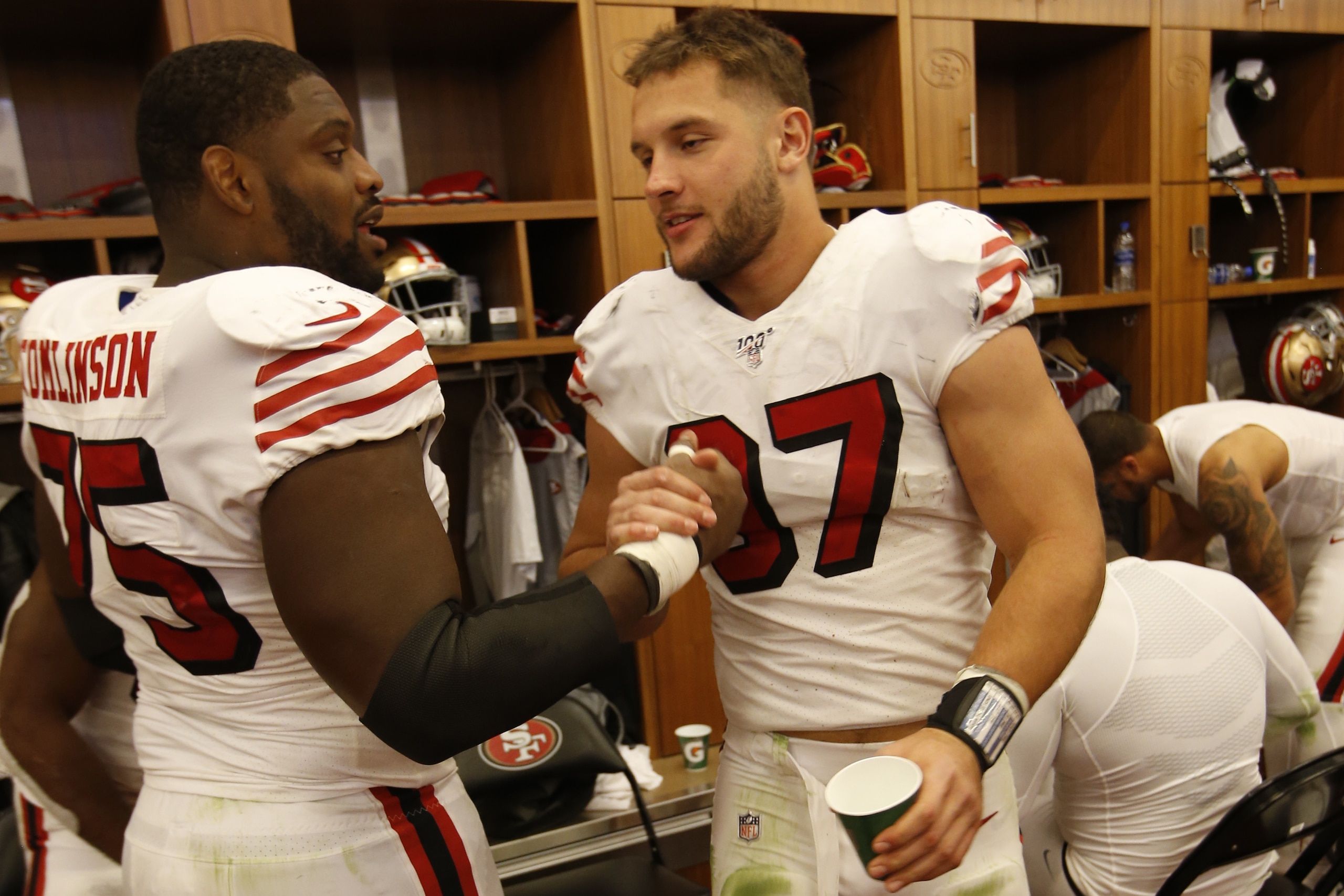 SANTA CLARA, CA - OCTOBER 27: Laken Tomlinson #75 and Nick Bosa #97 of the San Francisco 49ers celebrate in the locker room following the game against the Carolina Panthers at Levi's Stadium on October 27, 2019 in Santa Clara, California. The 49ers defeat SANTA CLARA, CA - OCTOBER 27: Laken Tomlinson #75 and Nick Bosa #97 of the San Francisco 49ers celebrate in the locker room following the game against the Carolina Panthers at Levi's Stadium on October 27, 2019 in Santa Clara, California. The 49ers defeat