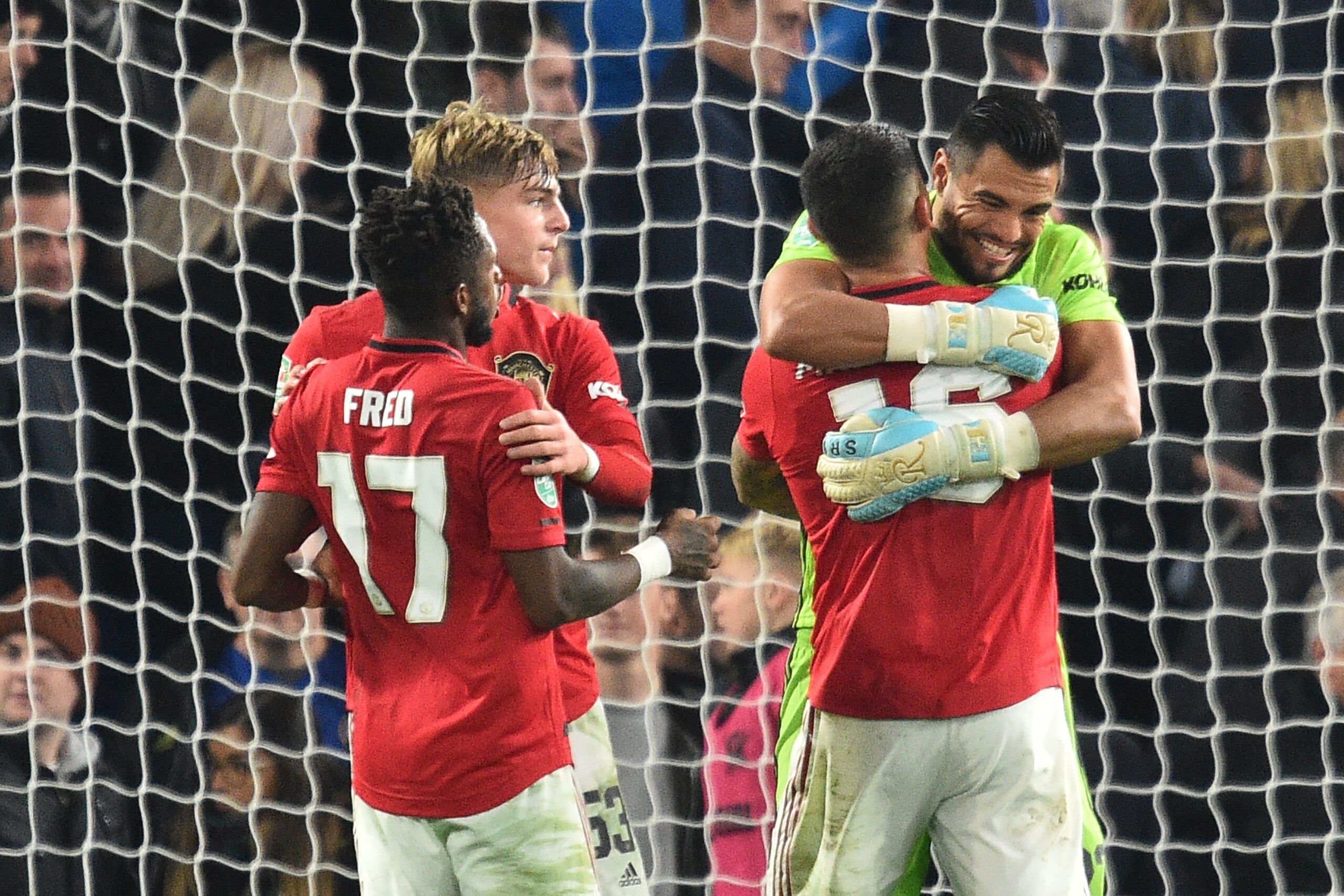 Manchester United's Argentinian goalkeeper Sergio Romero (R) and Manchester United's Argentinian defender Marcos Rojo gesture at the final whistle  during the English League Cup fourth round football match between Chelsea and Manchester United at Stamford