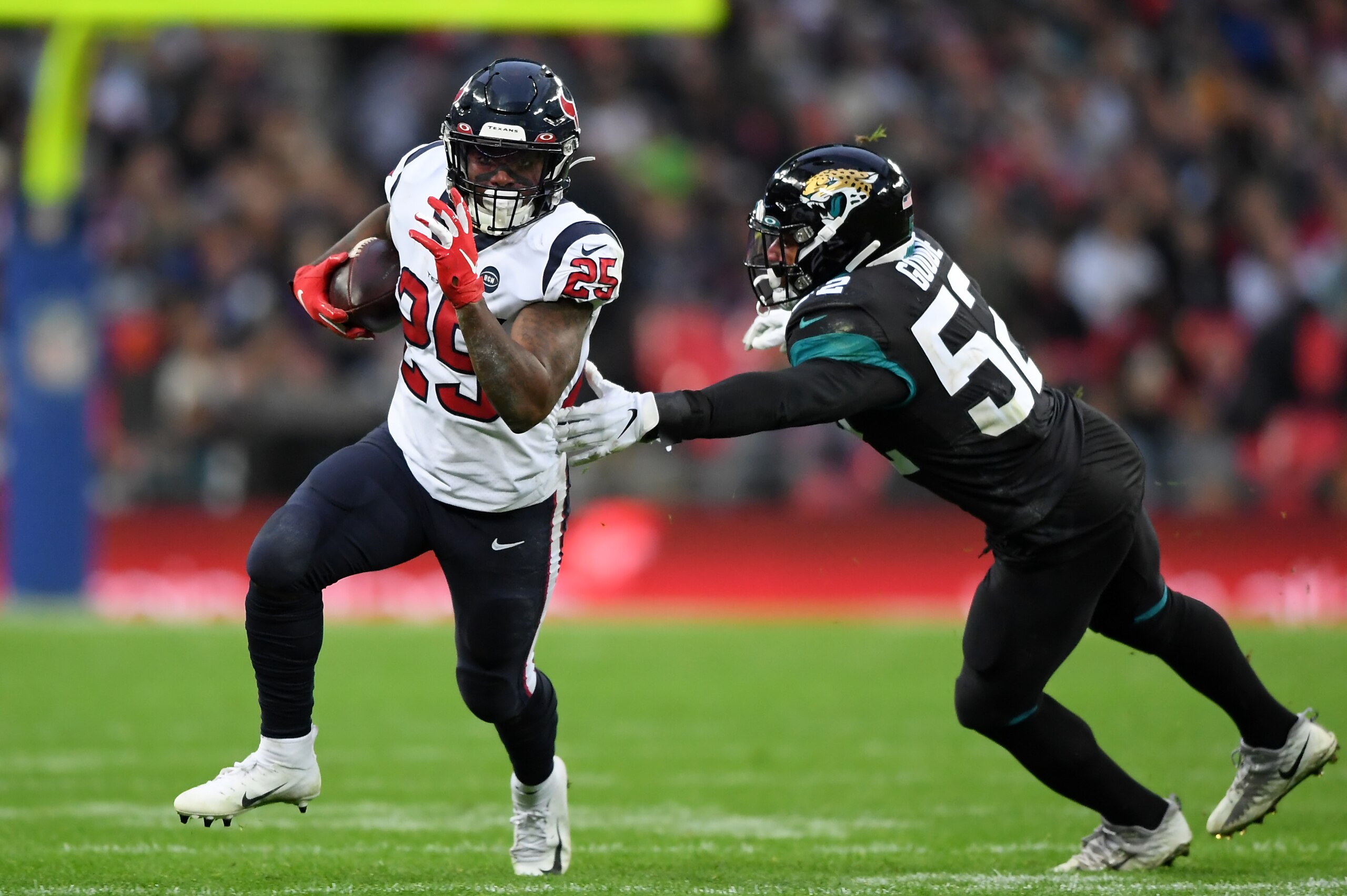 LONDON, ENGLAND - NOVEMBER 03: Duke Johnson of Houston Texans gets past Najee Goode of Jacksonville Jaguars during the NFL game between Houston Texans and  Jacksonville Jaguars at Wembley Stadium on November 03, 2019 in London, England. (Photo by Alex Dav