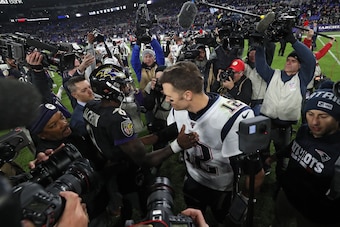 BALTIMORE, MARYLAND - NOVEMBER 03: Quarterback Lamar Jackson #8 of the Baltimore Ravens and quarterback Tom Brady #12 of the New England Patriots talk after the Ravens defeated the Patriots at M&T Bank Stadium on November 3, 2019 in Baltimore, Maryland. (