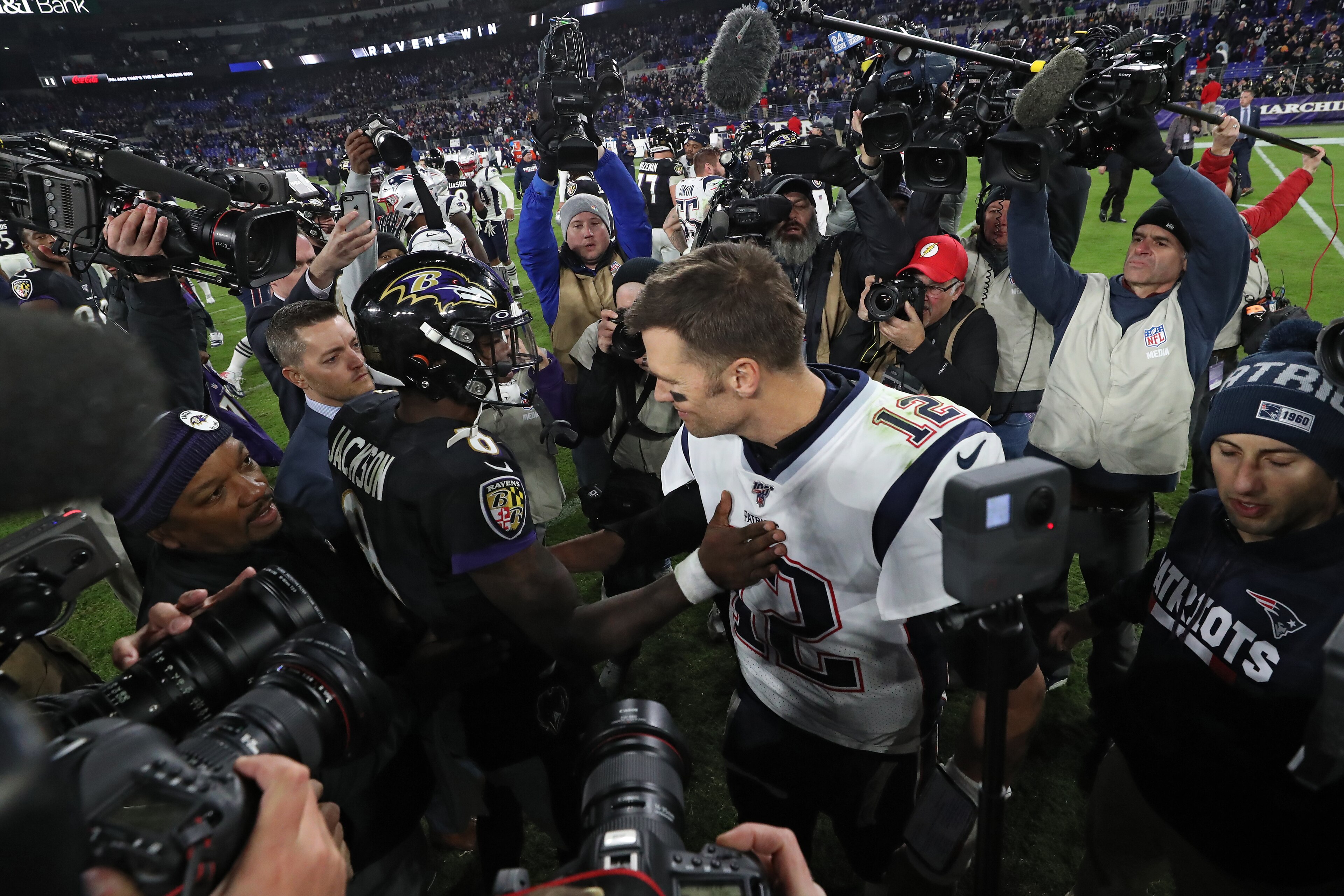 BALTIMORE, MARYLAND - NOVEMBER 03: Quarterback Lamar Jackson #8 of the Baltimore Ravens and quarterback Tom Brady #12 of the New England Patriots talk after the Ravens defeated the Patriots at M&T Bank Stadium on November 3, 2019 in Baltimore, Maryland. ( BALTIMORE, MARYLAND - NOVEMBER 03: Quarterback Lamar Jackson #8 of the Baltimore Ravens and quarterback Tom Brady #12 of the New England Patriots talk after the Ravens defeated the Patriots at M&T Bank Stadium on November 3, 2019 in Baltimore, Maryland. (