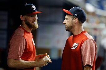 MIAMI, FLORIDA - APRIL 19: Max Scherzer #31 of the Washington Nationals talks with Stephen Strasburg #37 in the dugout against the Miami Marlins at Marlins Park on April 19, 2019 in Miami, Florida. (Photo by Michael Reaves/Getty Images)