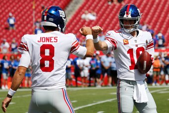 TAMPA, FLORIDA - SEPTEMBER 22: Quarterbacks Daniel Jones #8 and Eli Manning #10 of the New York Giants fist bump during warmups before the game against the Tampa Bay Buccaneers at Raymond James Stadium on September 22, 2019 in Tampa, Florida. (Photo by Mi