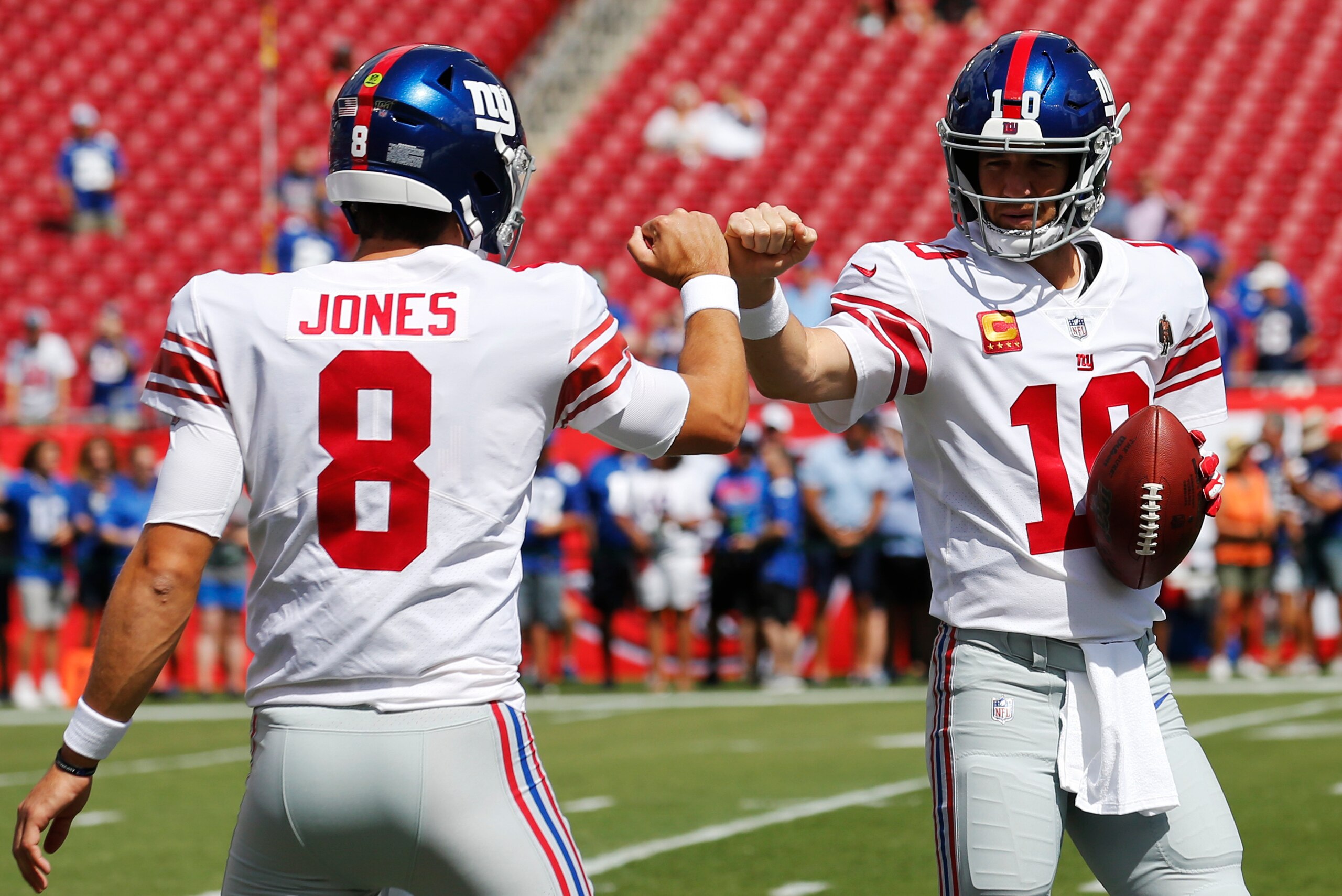 TAMPA, FLORIDA - SEPTEMBER 22: Quarterbacks Daniel Jones #8 and Eli Manning #10 of the New York Giants fist bump during warmups before the game against the Tampa Bay Buccaneers at Raymond James Stadium on September 22, 2019 in Tampa, Florida. (Photo by Mi