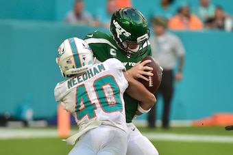 MIAMI, FL - NOVEMBER 03: Nik Needham #40 of the Miami Dolphins sacks Sam Darnold #14 of the New York Jets during the fourth quarter of the game at Hard Rock Stadium on November 3, 2019 in Miami, Florida. (Photo by Eric Espada/Getty Images)