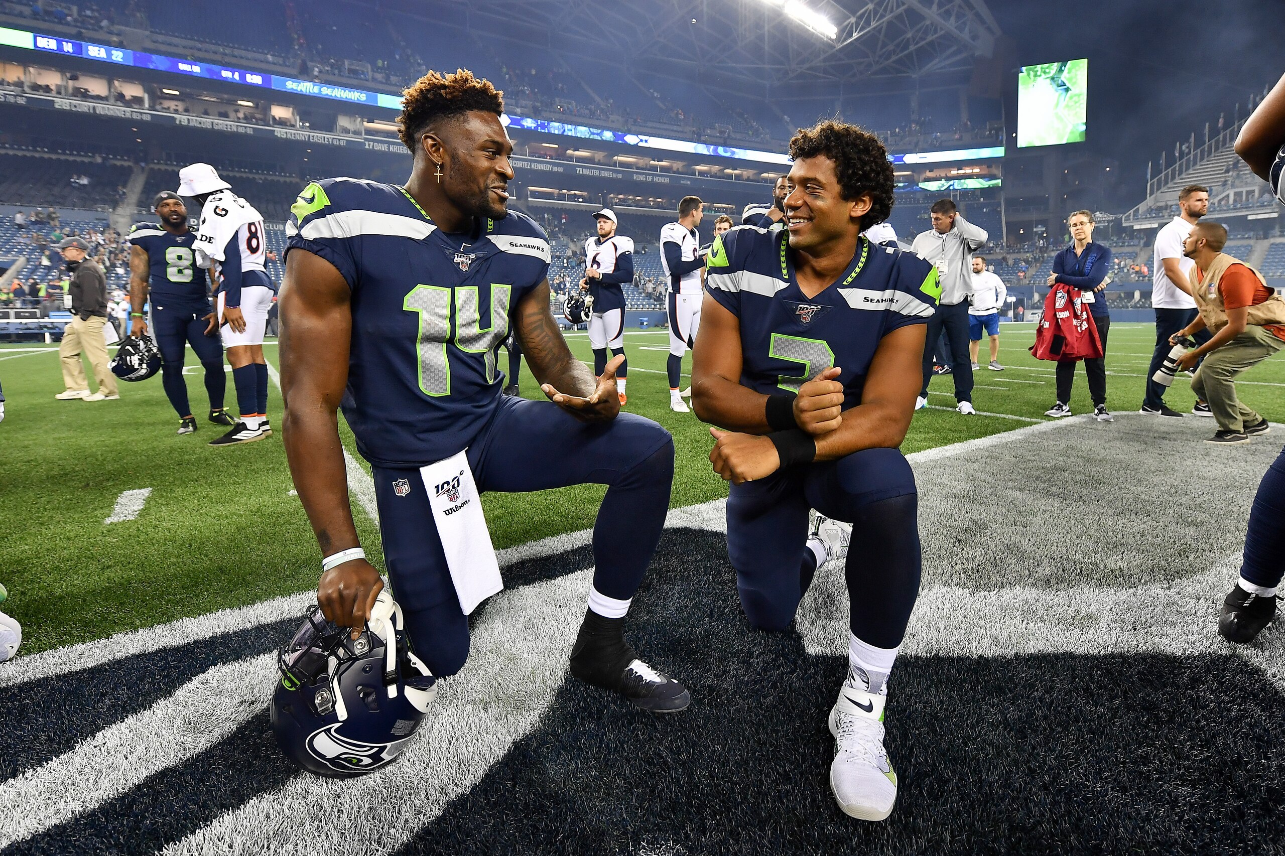 SEATTLE, WASHINGTON - AUGUST 08: D.K. Metcalf #14 and Russell Wilson #3 of the Seattle Seahawks have a chat after the preseason game victory over the Denver Broncos at CenturyLink Field on August 08, 2019 in Seattle, Washington. (Photo by Alika Jenner/Get