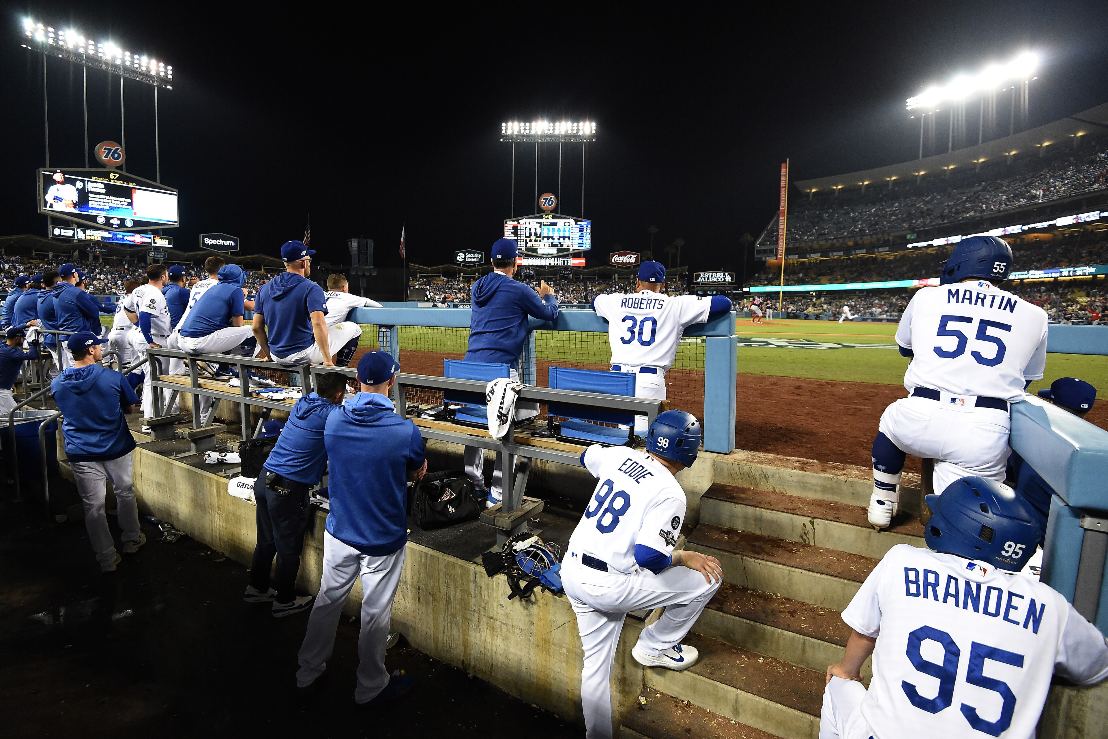 LOS ANGELES, CALIFORNIA - OCTOBER 09: The Los Angeles Dodgers look on from the dug out during the tenth inning en route to losing to the Washington Nationals 7-3 in game five and the National League Division Series at Dodger Stadium on October 09, 2019 in