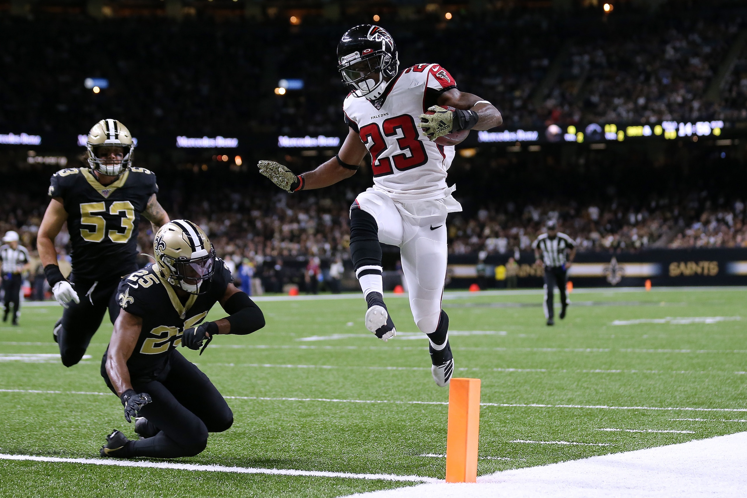 NEW ORLEANS, LOUISIANA - NOVEMBER 10: Brian Hill #23 of the Atlanta Falcons scores a touchdown as Eli Apple #25 of the New Orleans Saints and A.J. Klein #53 defends during the second half of a game at the Mercedes Benz Superdome on November 10, 2019 in Ne