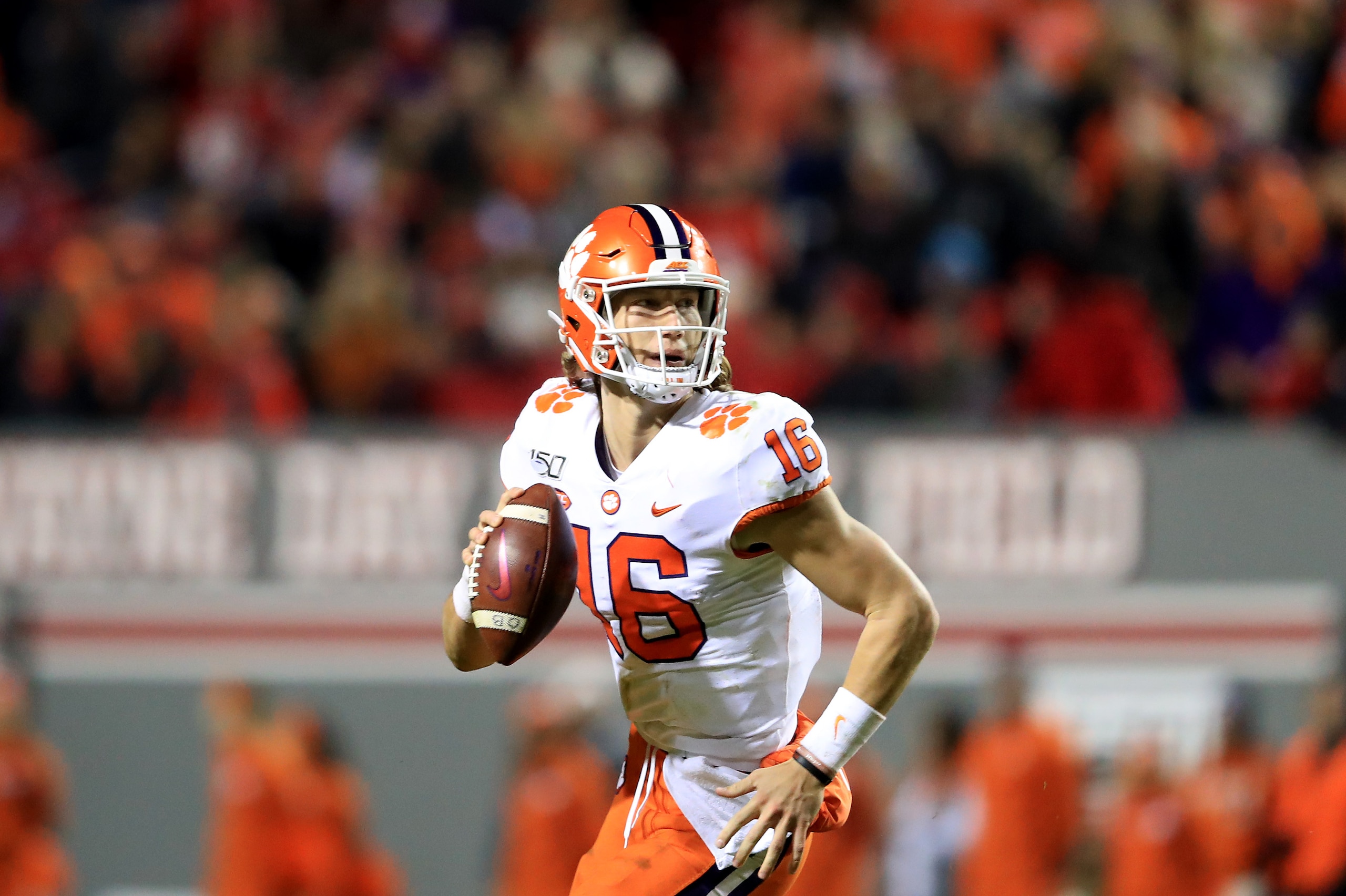 RALEIGH, NORTH CAROLINA - NOVEMBER 09: Trevor Lawrence #16 of the Clemson Tigers drops back to pass against the North Carolina State Wolfpack during their game at Carter-Finley Stadium on November 09, 2019 in Raleigh, North Carolina. (Photo by Streeter Le