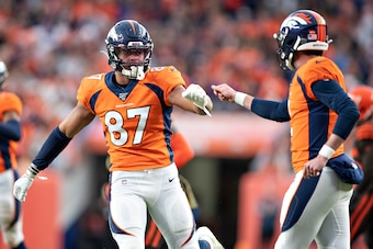 DENVER, CO - NOVEMBER 3:  Brandon Allen #2 is congratulated by Noah Fans #87 of the Denver Broncos after a touchdown during the second half of a game against the Cleveland Browns at Broncos Stadium at Mile High on November 3, 2019 in Denver, Colorado.  Th