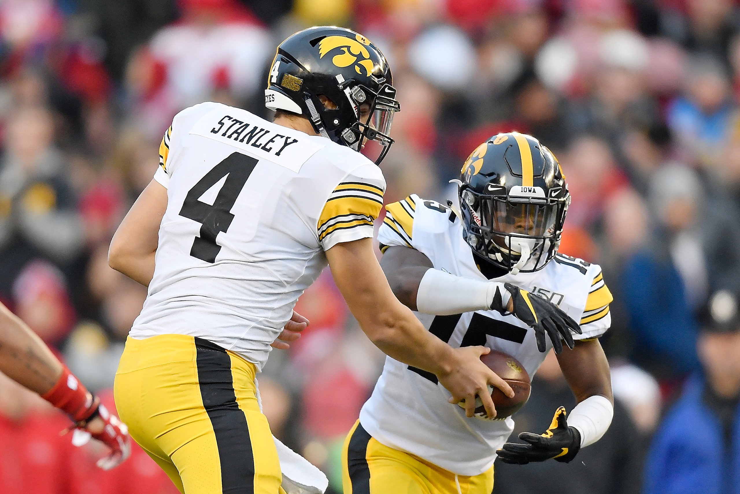 MADISON, WISCONSIN - NOVEMBER 09: Nate Stanley #4 of the Iowa Hawkeyes hands the football to Tyler Goodson #15 of the Iowa Hawkeyes in the second half against the Wisconsin Badgers at Camp Randall Stadium on November 09, 2019 in Madison, Wisconsin. (Photo