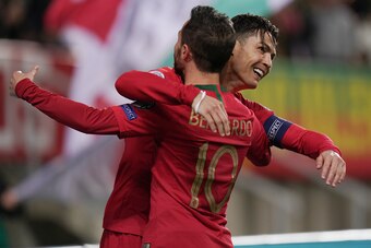 FARO, PORTUGAL - NOVEMBER 14:  Cristiano Ronaldo of Portugal and Juventus celebrates with teammate Bernardo Silva of Portugal and Manchester City after scoring a goal during the UEFA Euro 2020 Qualifier match between Portugal and Lithuania at Estadio Alga