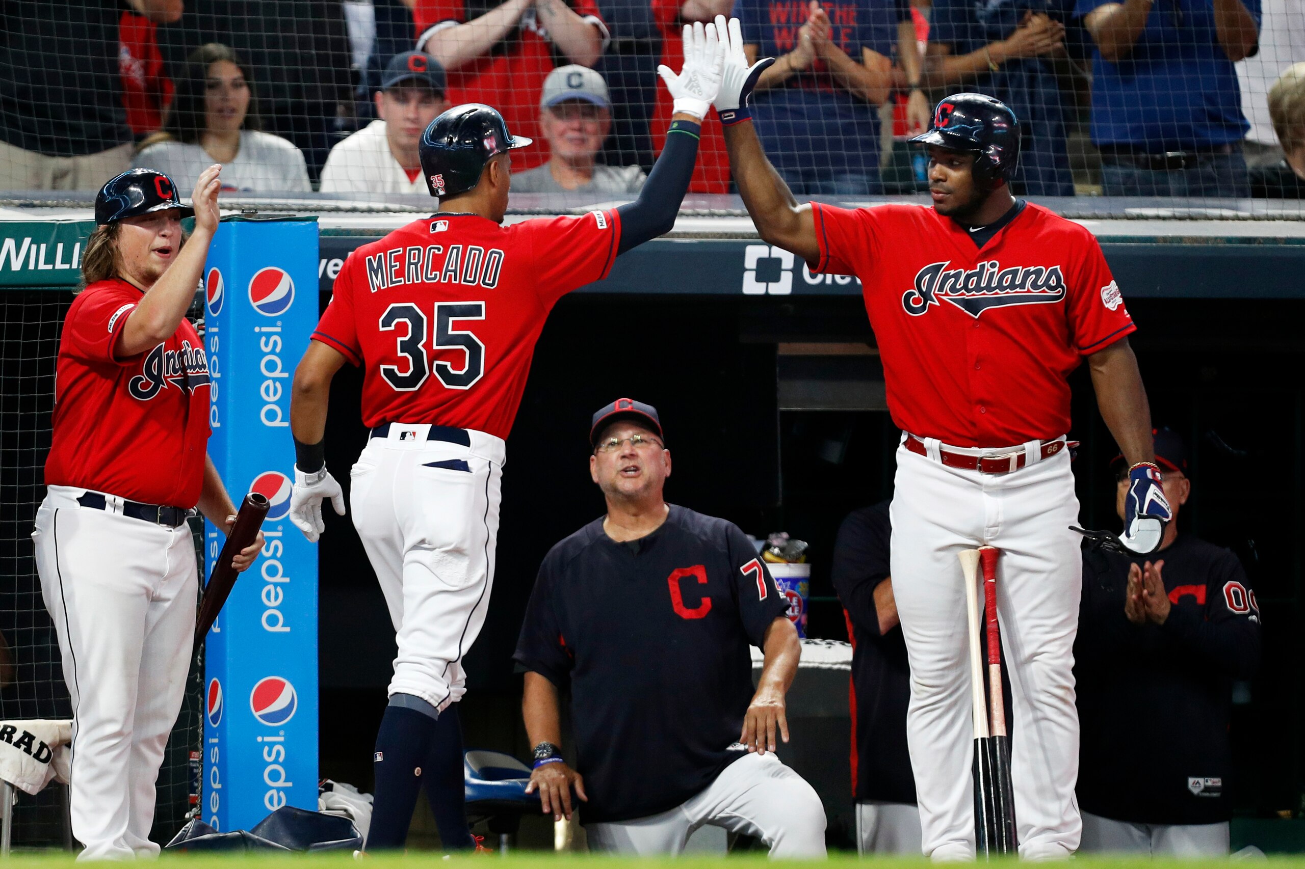 CLEVELAND, OH - SEPTEMBER 21: Oscar Mercado #35 is congratulated by Yasiel Puig #66 of the Cleveland Indians as Manager Terry Francona #77 looks on after hitting a two run home run against the Philadelphia Phillies during the second inning at Progressive 