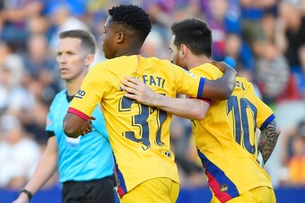 Barcelona's Argentine forward Lionel Messi *R( celebrates with Barcelona's Guinea-Bissau forward Ansu Fati an eventually cancelled goal during the Spanish League football match between Levante UD and FC Barcelona at the Ciutat de Valencia stadium in Valen
