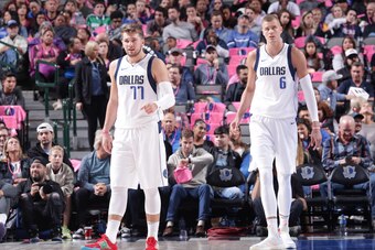 DALLAS, TX - OCTOBER 11: Luka Doncic #77, and Kristaps Porzingis #6 of the Dallas Mavericks looks on against the Milwaukee Bucks during a pre-season game on October 11, 2019 at the American Airlines Center in Dallas, Texas. NOTE TO USER: User expressly ac