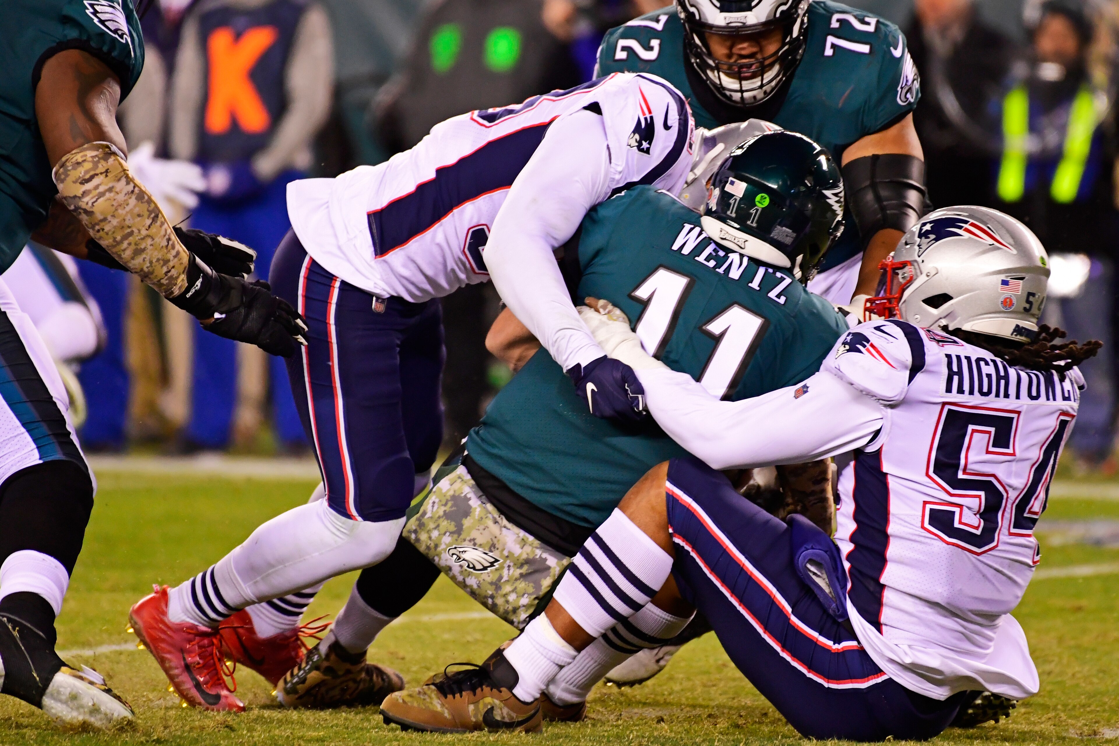 PHILADELPHIA, PA - NOVEMBER 17: Carson Wentz #11 of the Philadelphia Eagles is sacked by Kyle Van Noy #53 (L) of the New England Patriots and Dont'a Hightower #54 during the third quarter at Lincoln Financial Field on November 17, 2019 in Philadelphia, Pe