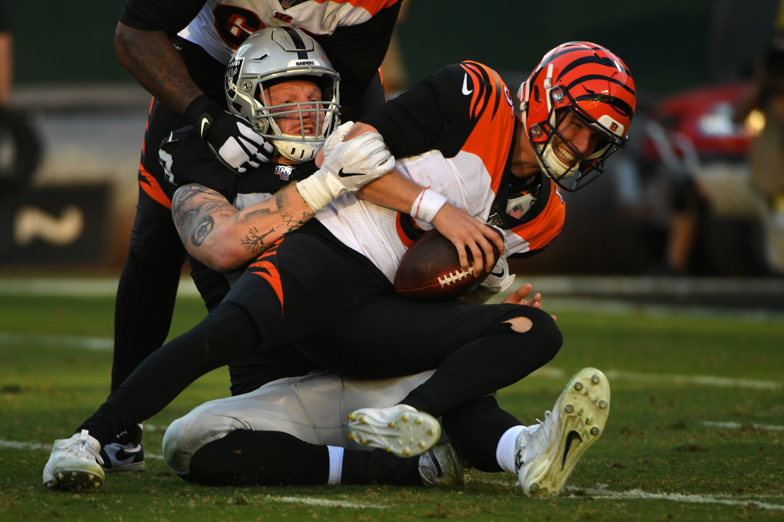 OAKLAND, CALIFORNIA - NOVEMBER 17: Maxx Crosby #98 of the Oakland Raiders sacks Ryan Finley #5 of the Cincinnati Bengals during their NFL game at RingCentral Coliseum on November 17, 2019 in Oakland, California. (Photo by Robert Reiners/Getty Images)
