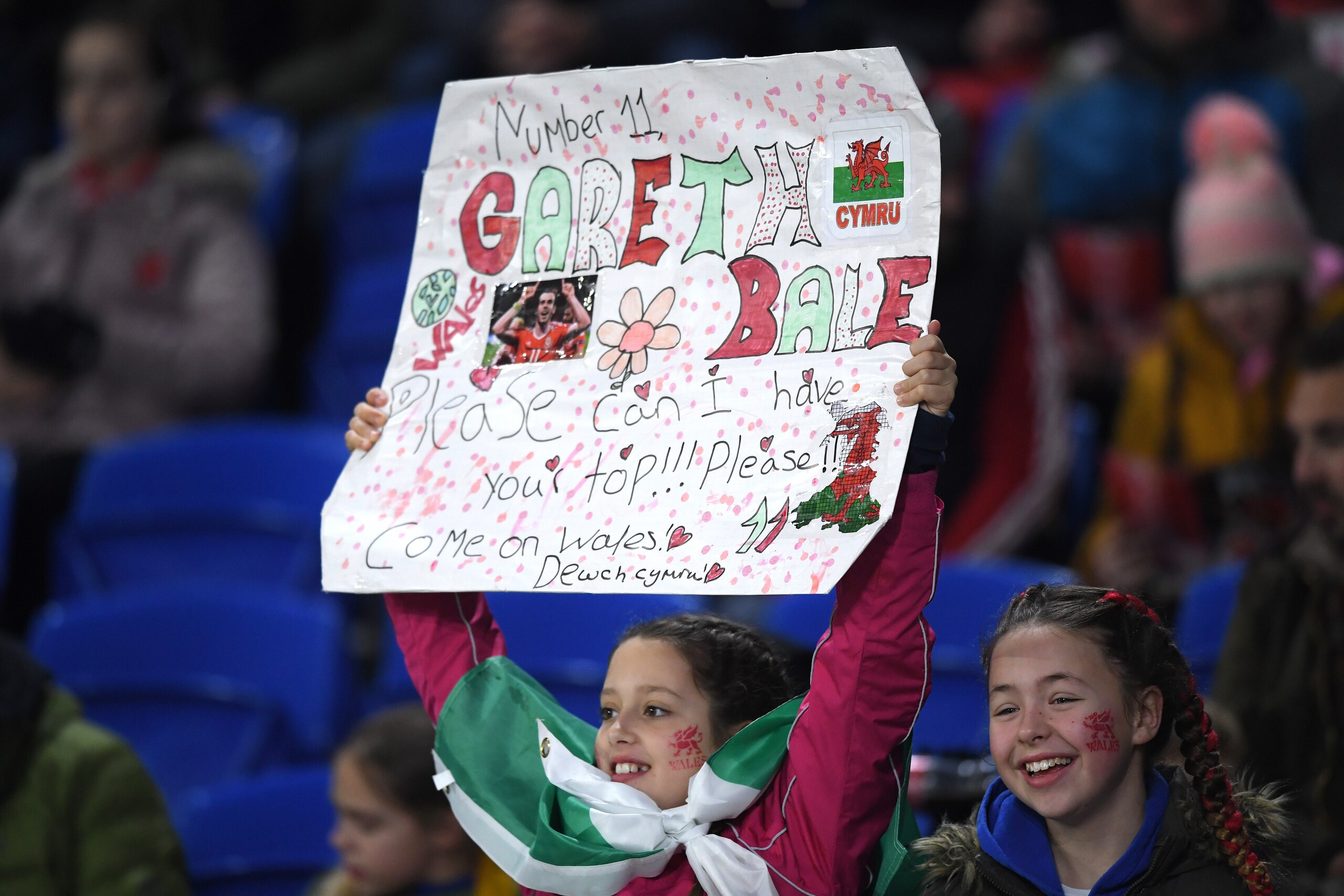 CARDIFF, WALES - NOVEMBER 19: A young female fan holds up a self made oster requesting the shirt of Wales player Gareth Bale during the UEFA Euro 2020 qualifier between Wales and Hungary  at Cardiff City Stadium on November 19, 2019 in Cardiff, Wales. (Ph