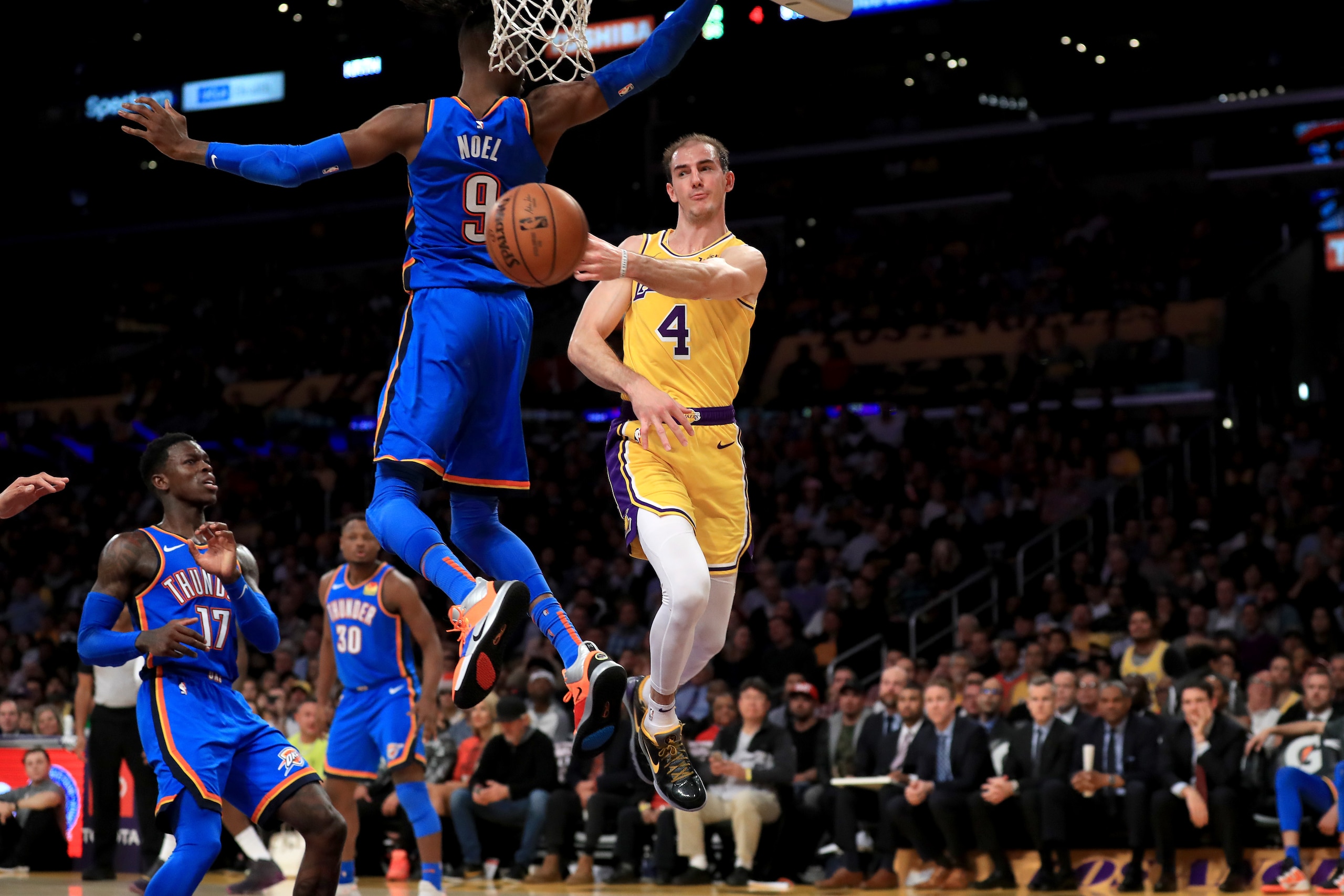 LOS ANGELES, CALIFORNIA - NOVEMBER 19:  Alex Caruso #4 of the Los Angeles Lakers passes the ball past the defense of Nerlens Noel #9 of the Oklahoma City Thunder during the second half of a game at Staples Center on November 19, 2019 in Los Angeles, Calif