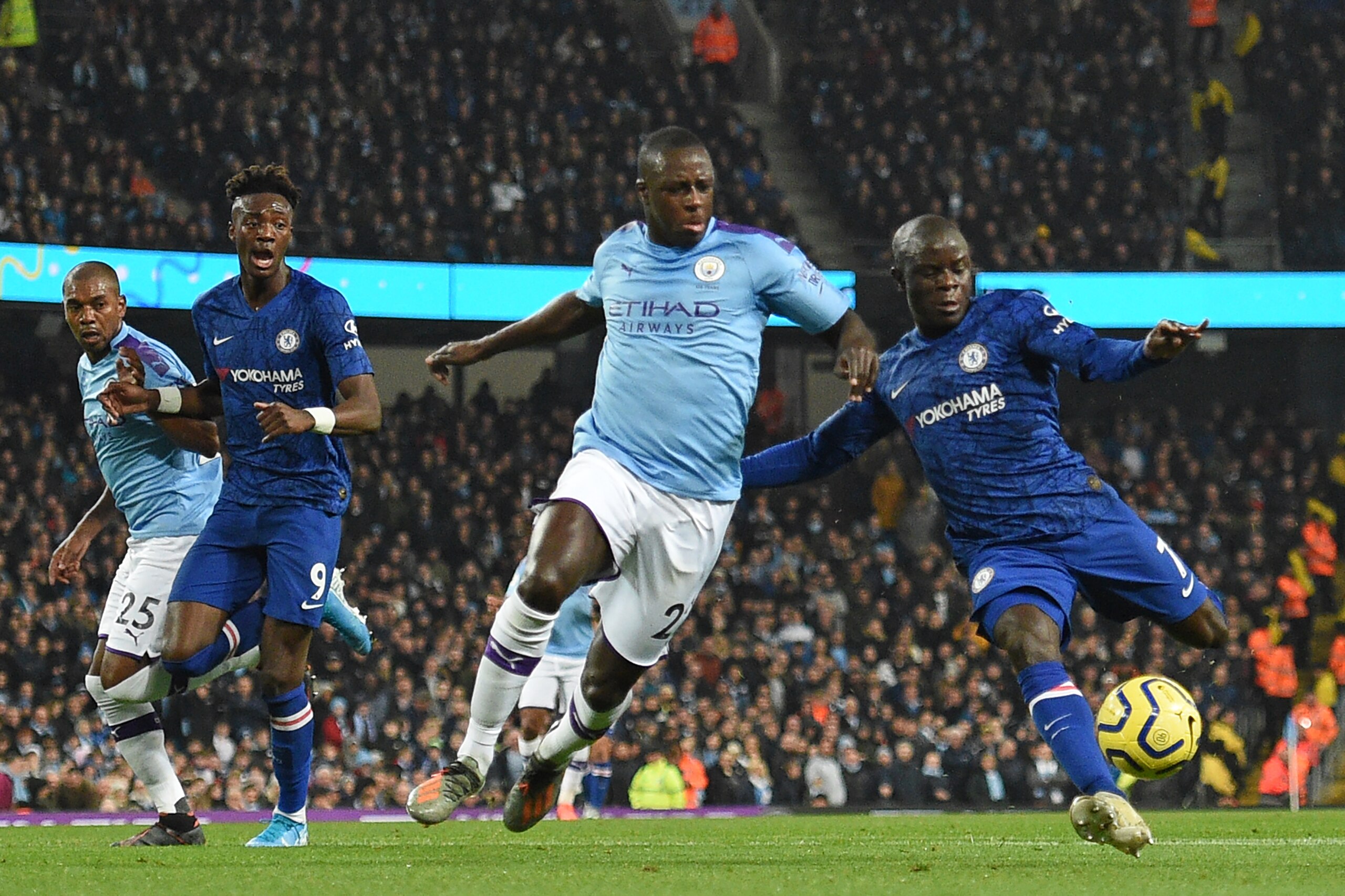 Chelsea's French midfielder N'Golo Kante (R) prepares to shoot past Manchester City's French defender Benjamin Mendy (2nd R) to score the opening goal of the English Premier League football match between Manchester City and Chelsea at the Etihad Stadium i