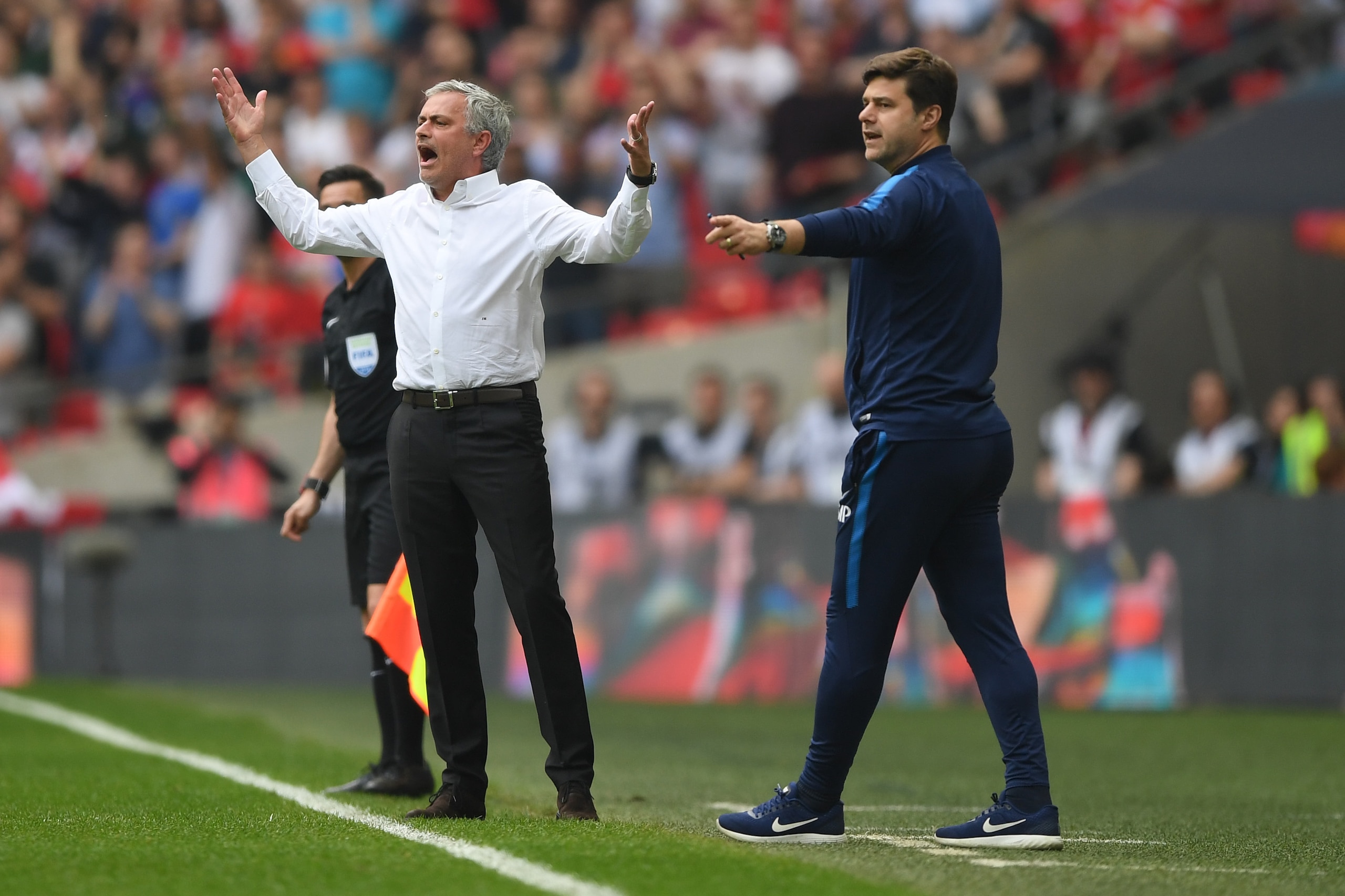 LONDON, ENGLAND - APRIL 21:  Jose Mourinho, Manager of Manchester United reacts as Mauricio Pochettino, Manager of Tottenham Hotspur gives his team instructions during The Emirates FA Cup Semi Final match between Manchester United and Tottenham Hotspur at