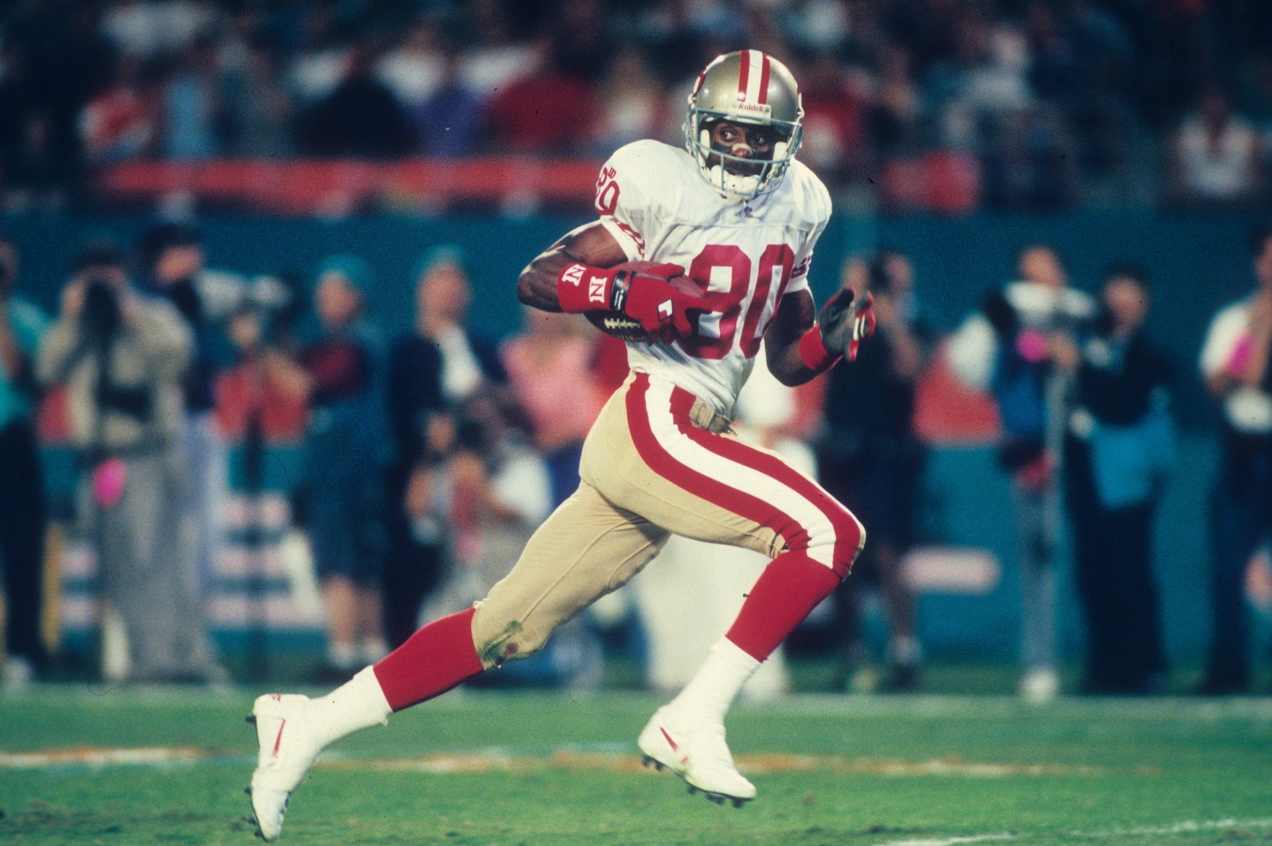 MIAMI, FL - NOVEMBER 20:  Wide receiver Jerry Rice #80 of the San Francisco 49ers races upfield against the Miami Dolphins at Joe Robbie Stadium in Miami, Florida on November 20, 1995. The 49ers defeated the Dolphins 44-20. (Photo by Joseph Patronite/Gett