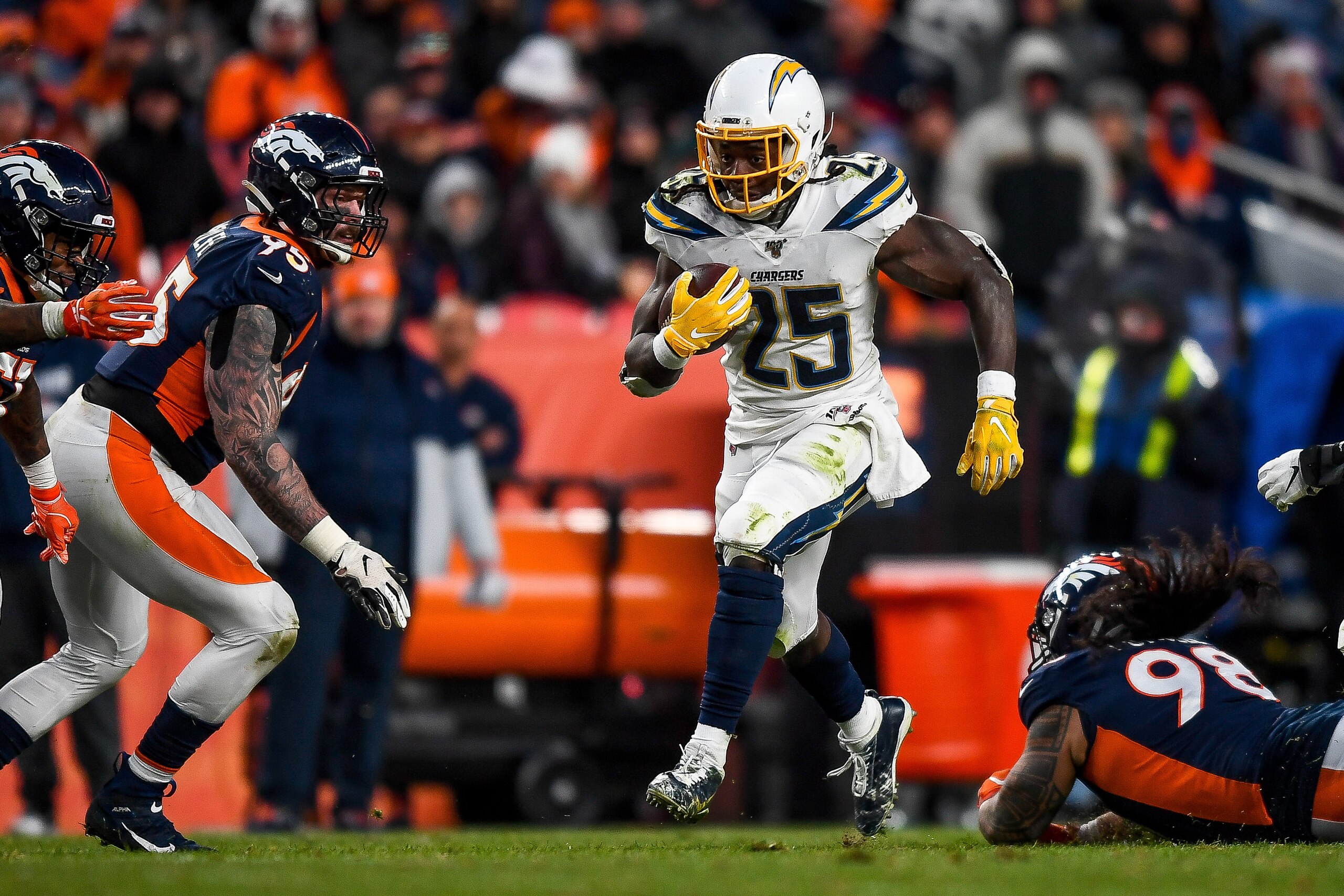 DENVER, CO - DECEMBER 1: Melvin Gordon #25 of the Los Angeles Chargers rushes against the Denver Broncos in the fourth quarter of a game at Empower Field at Mile High on December 1, 2019 in Denver, Colorado. (Photo by Dustin Bradford/Getty Images) DENVER, CO - DECEMBER 1: Melvin Gordon #25 of the Los Angeles Chargers rushes against the Denver Broncos in the fourth quarter of a game at Empower Field at Mile High on December 1, 2019 in Denver, Colorado. (Photo by Dustin Bradford/Getty Images)