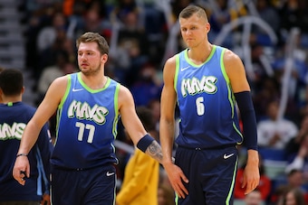 NEW ORLEANS, LOUISIANA - DECEMBER 03: Luka Doncic #77 of the Dallas Mavericks and Kristaps Porzingis #6 walk the floor during a break in the action against the New Orleans Pelicans in the first half at the Smoothie King Center on December 03, 2019 in New 