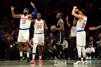 NEW YORK, NEW YORK - OCTOBER 25: Taurean Prince #2 of the Brooklyn Nets looks on as Marcus Morris Sr. #13, Julius Randle #30 and Kevin Knox II #20 of the New York Knicks react to a call during the second half of their game at Barclays Center on October 25