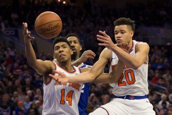PHILADELPHIA, PA - NOVEMBER 28: Allonzo Trier #14 and Kevin Knox #20 of the New York Knicks reach for the ball against Wilson Chandler #22 of the Philadelphia 76ers in the second quarter at the Wells Fargo Center on November 28, 2018 in Philadelphia, Penn