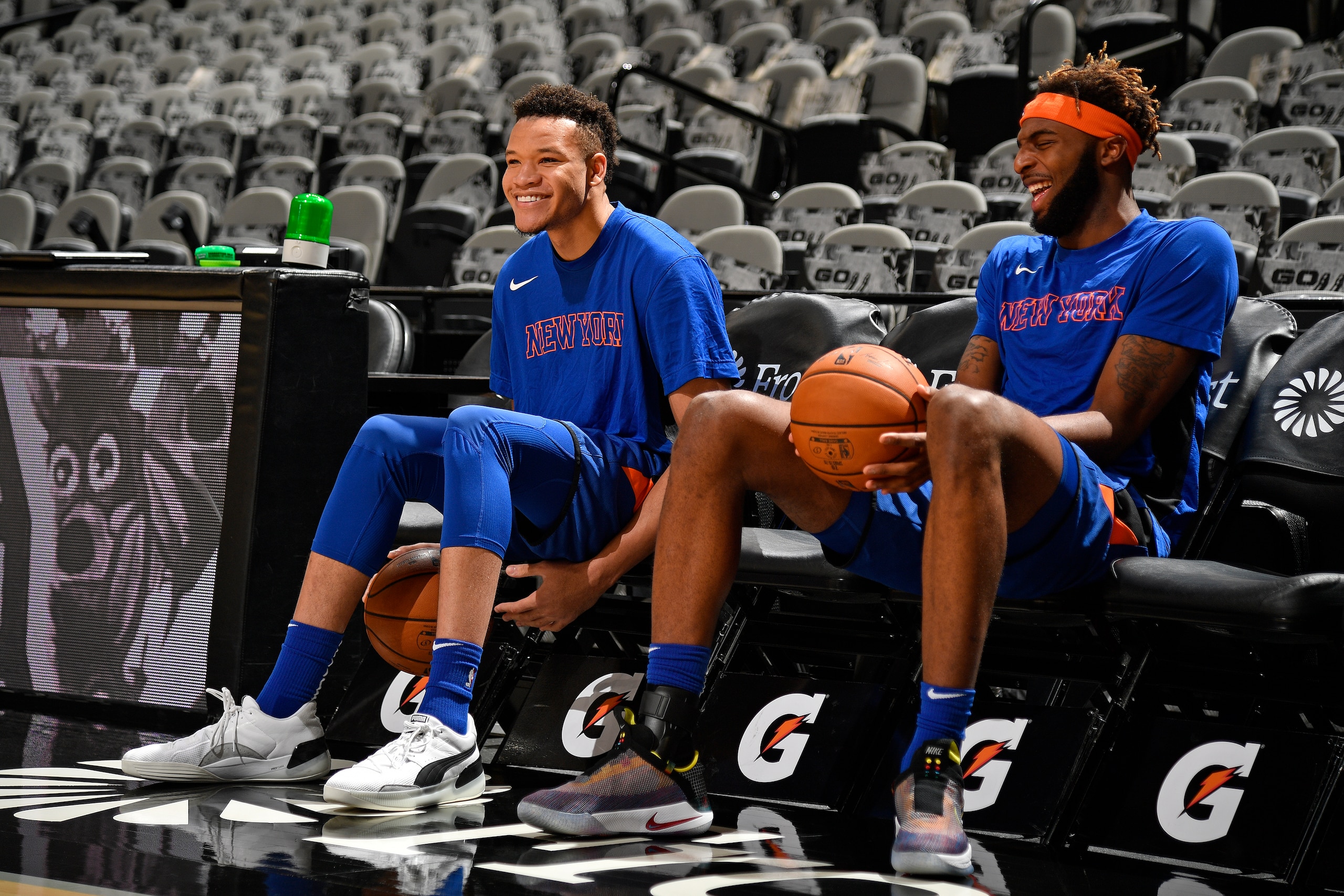 SAN ANTONIO, TX - OCTOBER 23: Kevin Knox #20 and Mitchell Robinson #23 of the New York Knicks smile and laugh on the bench before the game against the San Antonio Spurs on October 23, 2019 at the AT&T Center in San Antonio, Texas. NOTE TO USER: User expre