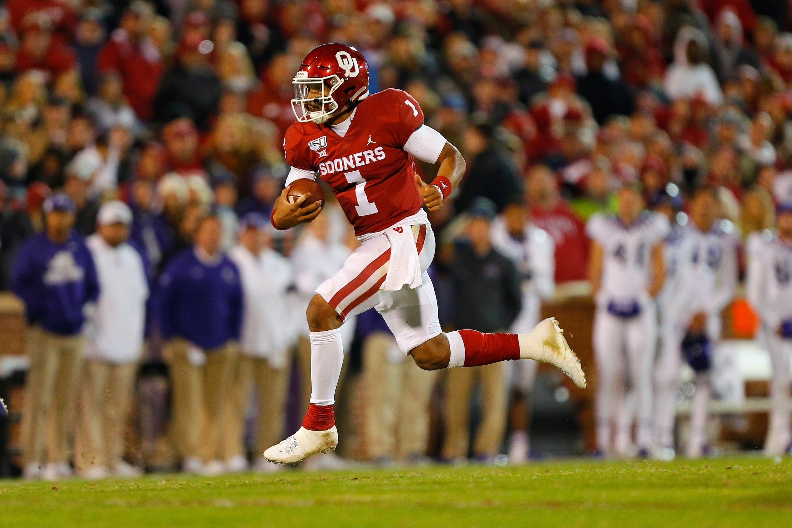 NORMAN, OK - NOVEMBER 23:  Quarterback Jalen Hurts #1 of the Oklahoma Sooners makes a 19-yard gain on a carry against the TCU Horned Frogs in the third quarter on November 23, 2019 at Gaylord Family Oklahoma Memorial Stadium in Norman, Oklahoma.  OU held 
