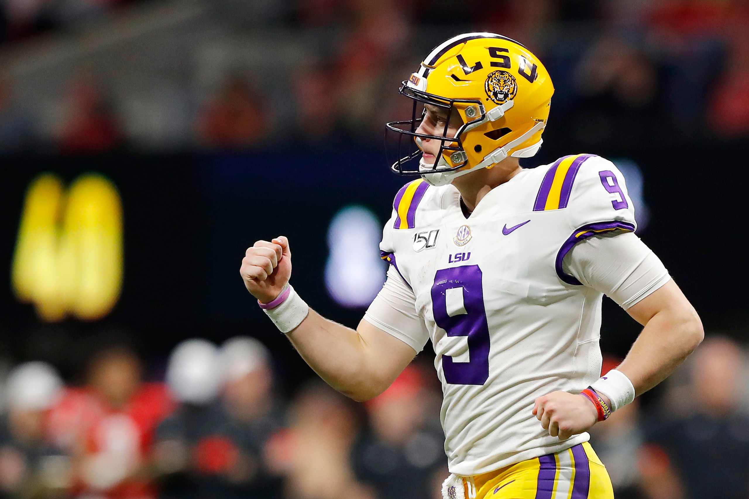 ATLANTA, GEORGIA - DECEMBER 07: Joe Burrow #9 of the LSU Tigers celebrates after throwing a touchdown pass to Terrace Marshall Jr. #6 (not pictured) in the third quarter against the Georgia Bulldogs during the SEC Championship game at Mercedes-Benz Stadiu