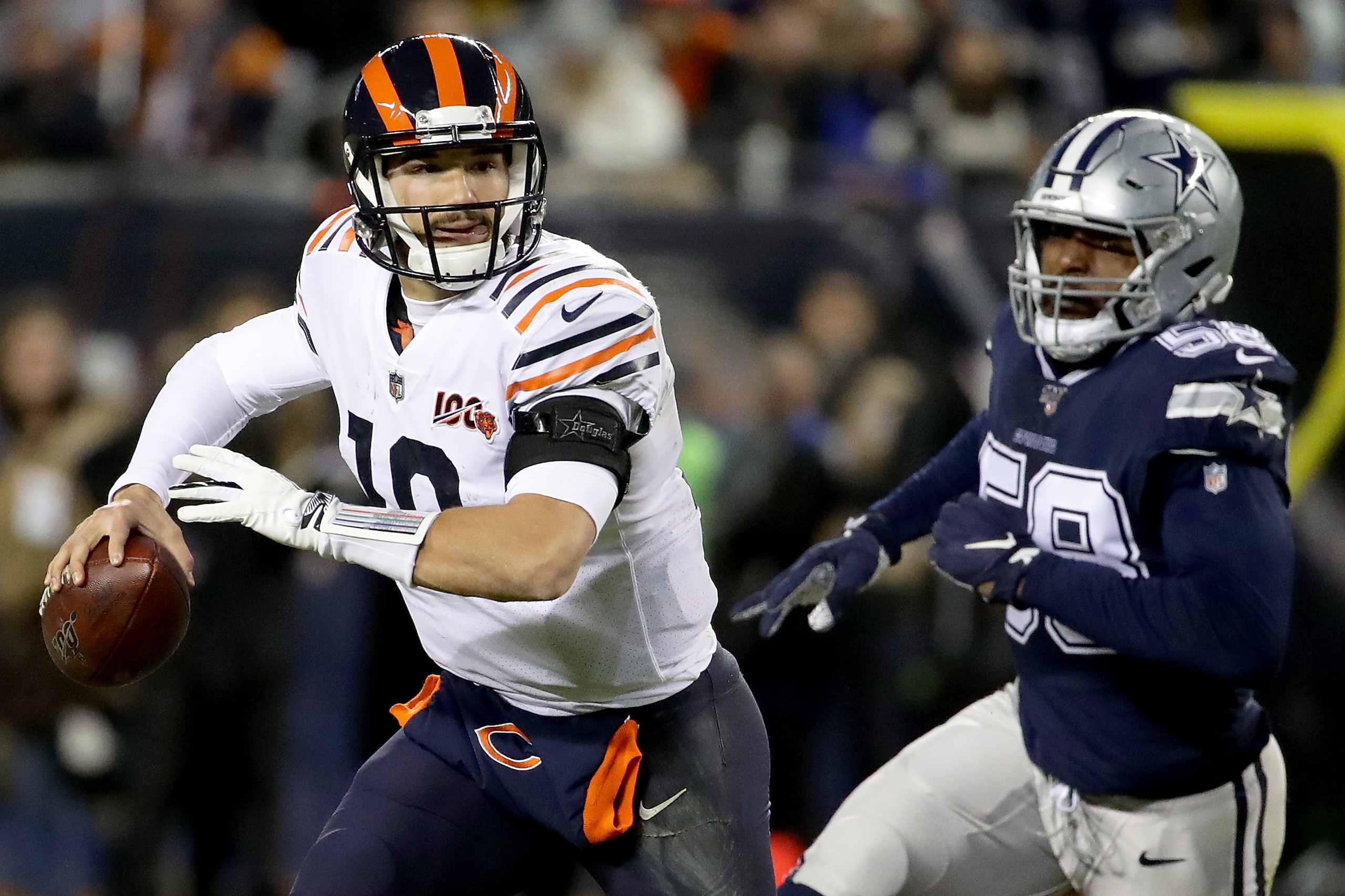 CHICAGO, ILLINOIS - DECEMBER 05:Quarterback Mitchell Trubisky #10 of the Chicago Bears scrambles against defensive end Robert Quinn #58 of the Dallas Cowboys during the game at Soldier Field on December 05, 2019 in Chicago, Illinois. (Photo by Jonathan Da
