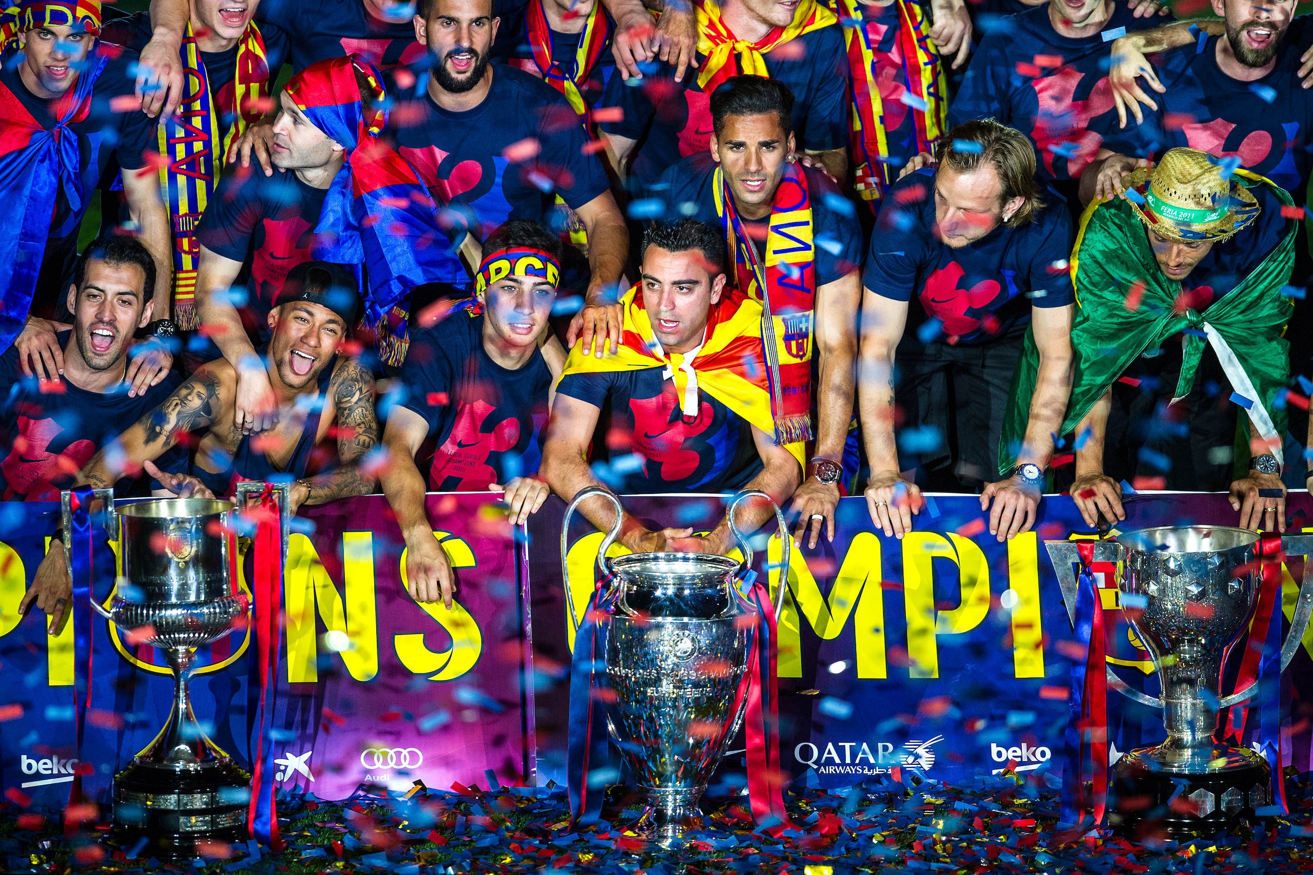 BARCELONA, SPAIN - JUNE 07: FC Barcelona players celebrate with La Liga, Copa del Rey and Champions League trophies during their victory parade after winning the UEFA Champions League Final at the Camp Nou Stadium on June 7, 2015 in Barcelona, Spain. (Pho