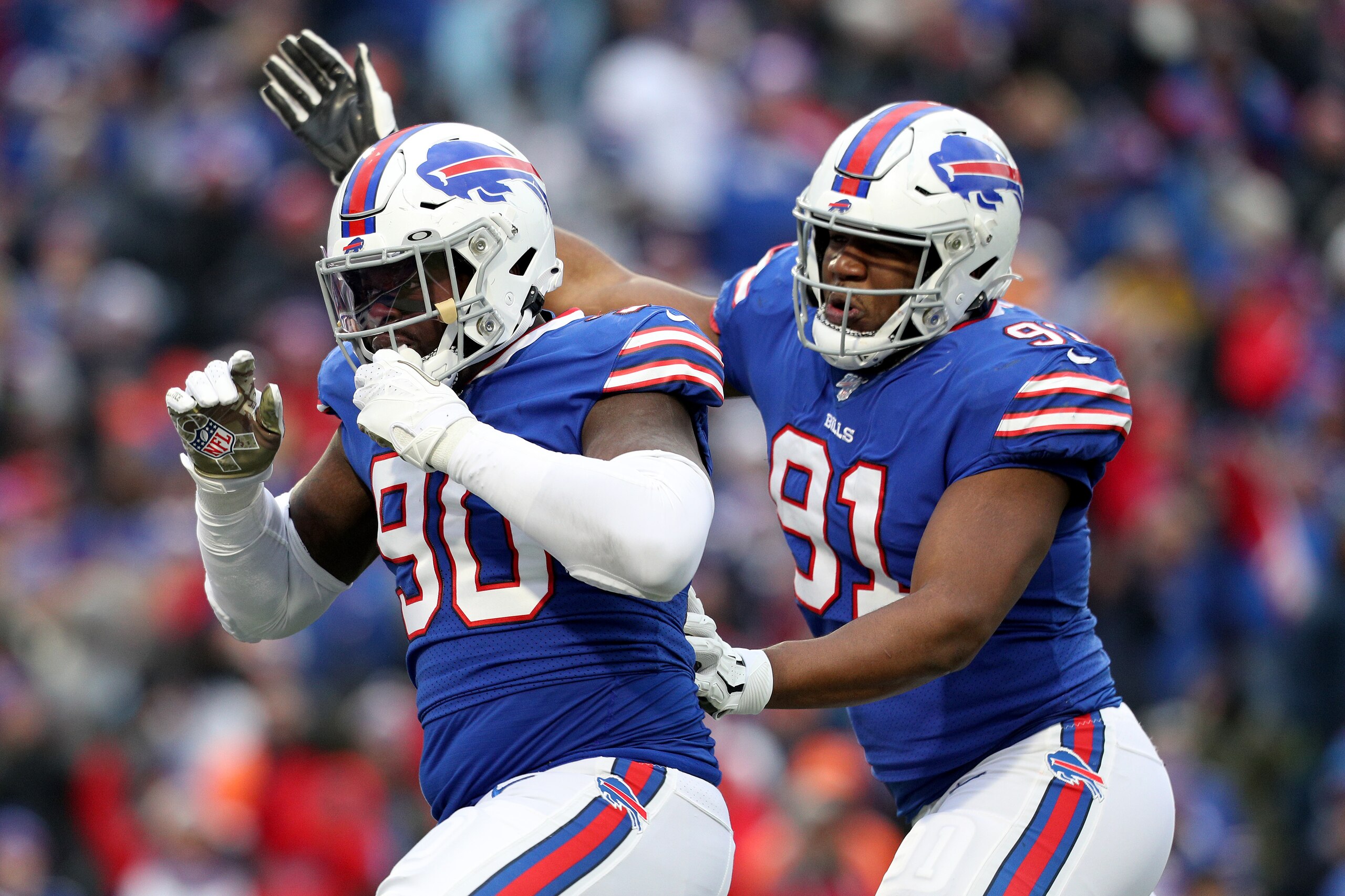 ORCHARD PARK, NEW YORK - NOVEMBER 24: Shaq Lawson #90 and teammate Ed Oliver #91, both of the Buffalo Bills, celebrate after a sack during the third quarter of an NFL game against the Denver Broncos at New Era Field on November 24, 2019 in Orchard Park, N