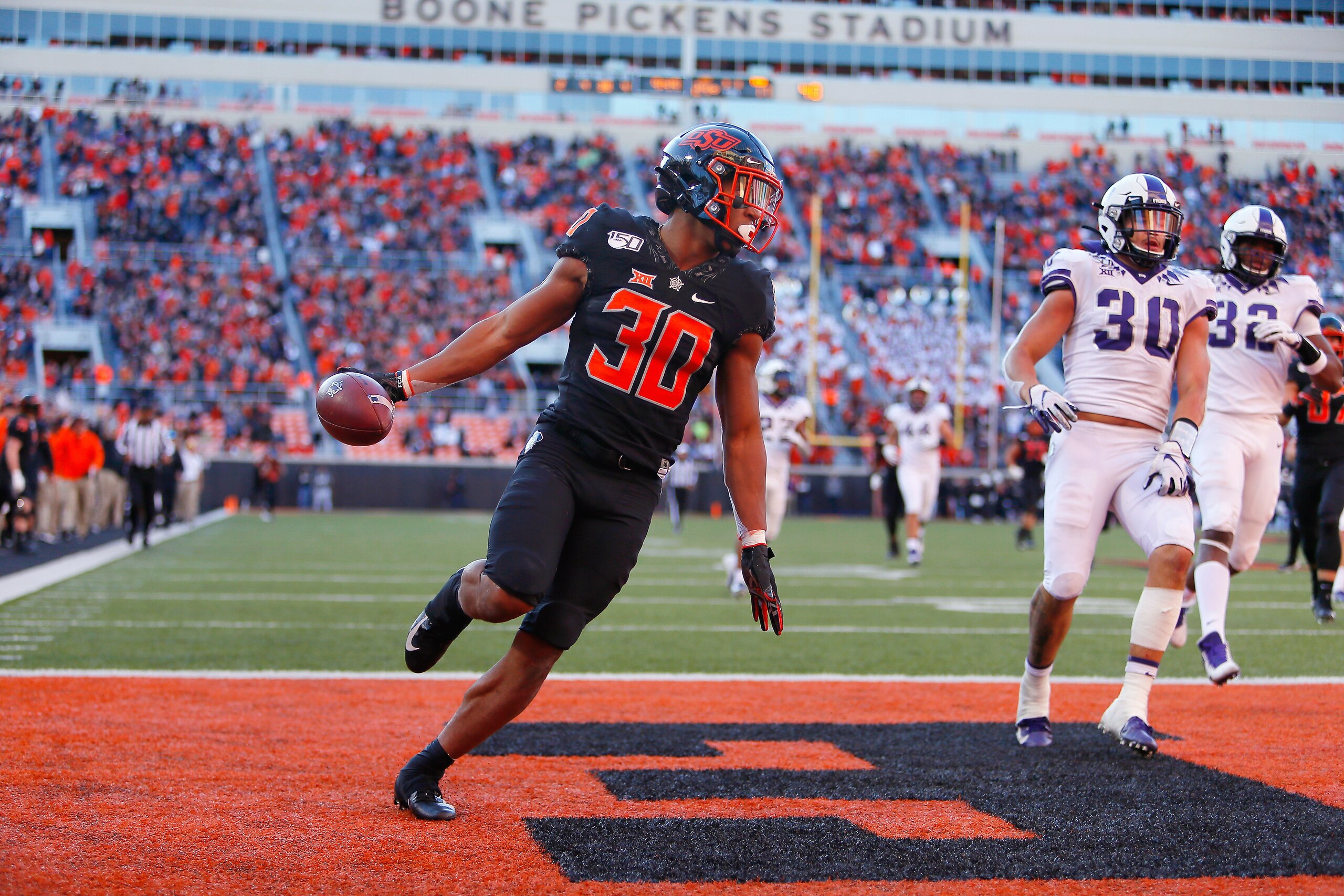 STILLWATER, OK - NOVEMBER 2: Running back Chuba Hubbard #30 of the Oklahoma State Cowboys scores a touchdown on a 62-yard run against the TCU Horned Frogs in the fourth quarter on November 2, 2019 at Boone Pickens Stadium in Stillwater, Oklahoma. Hubbar STILLWATER, OK - NOVEMBER 2: Running back Chuba Hubbard #30 of the Oklahoma State Cowboys scores a touchdown on a 62-yard run against the TCU Horned Frogs in the fourth quarter on November 2, 2019 at Boone Pickens Stadium in Stillwater, Oklahoma. Hubbar