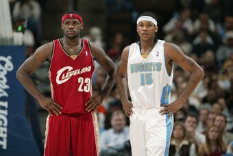 DENVER -DECEMBER 2:  LeBron James #23 of the Cleveland Cavaliers and Carmelo Anthony #15 of the Denver Nuggets look on during the game at the Pepsi Center in Denver, Colorado on December 2, 2003.  The Nuggets won 115-103.  NOTE TO USER: User expressly ack