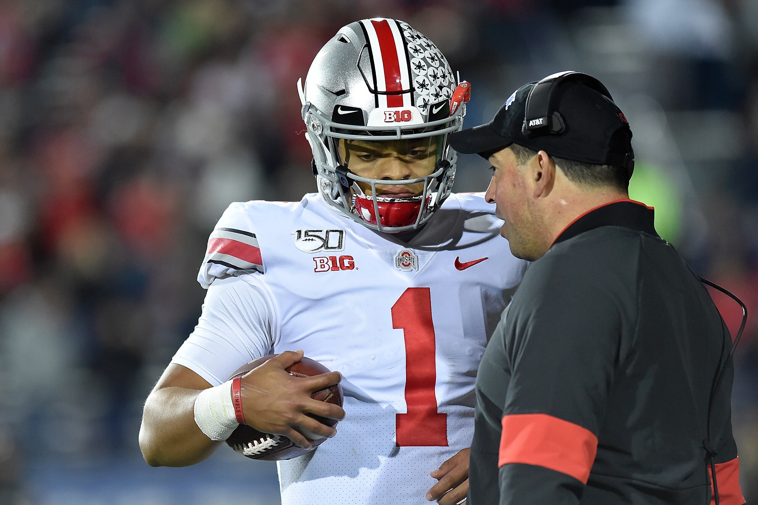 EVANSTON, ILLINOIS - OCTOBER 18: Justin Fields #1 of the Ohio State Buckeyes discusses with head coach Ryan Day of the Ohio State Buckeyes against the Northwestern Wildcats at Ryan Field on October 18, 2019 in Evanston, Illinois. (Photo by Quinn Harris/Ge