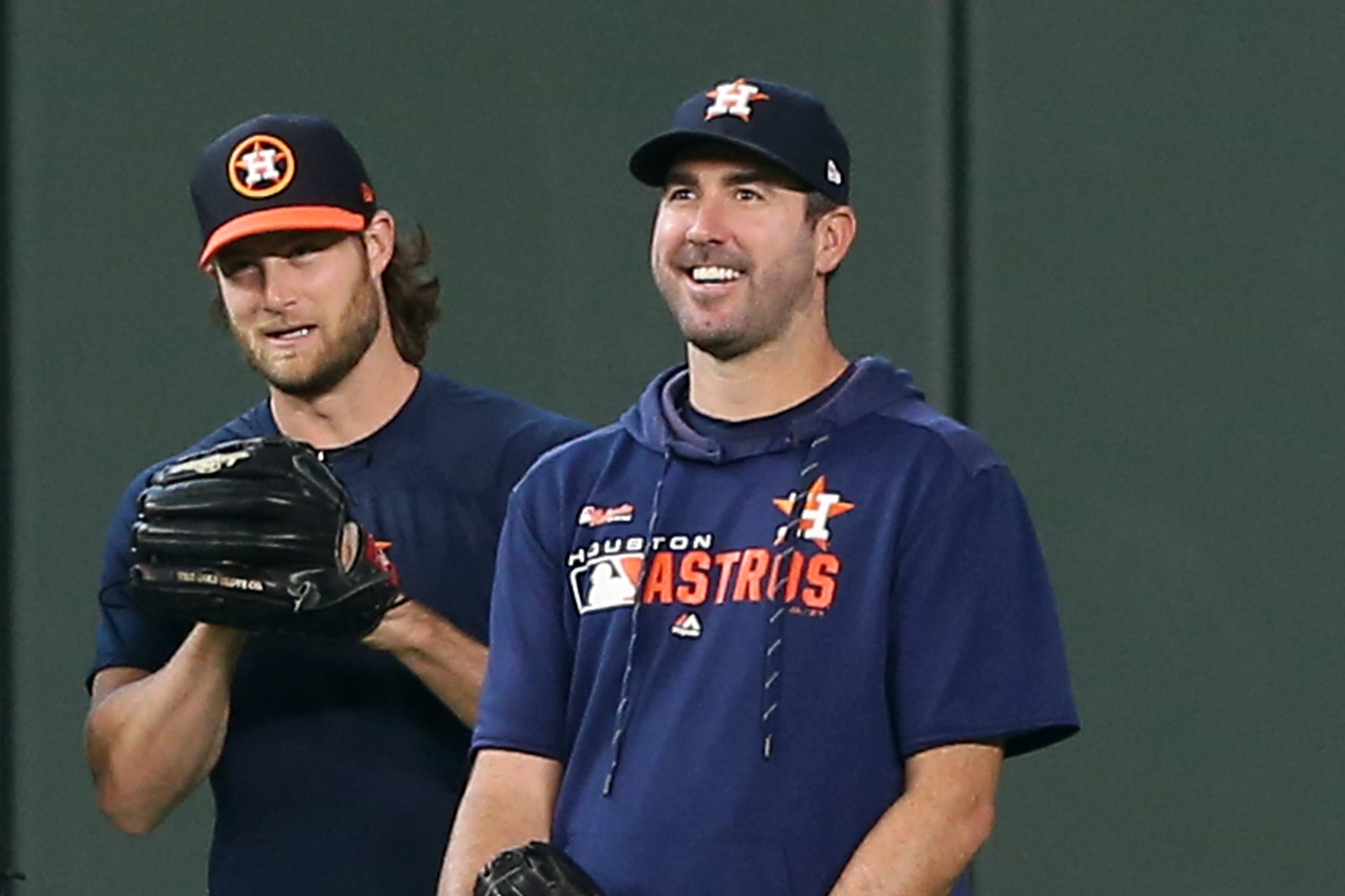 HOUSTON, TEXAS - AUGUST 03: (L-R) Wade Miley #20 of the Houston Astros, Joe Smith #38, Gerrit Cole #45 and Justin Verlander #35 chat during batting practice before a game against the Seattle Mariners at Minute Maid Park on August 03, 2019 in Houston, Texa