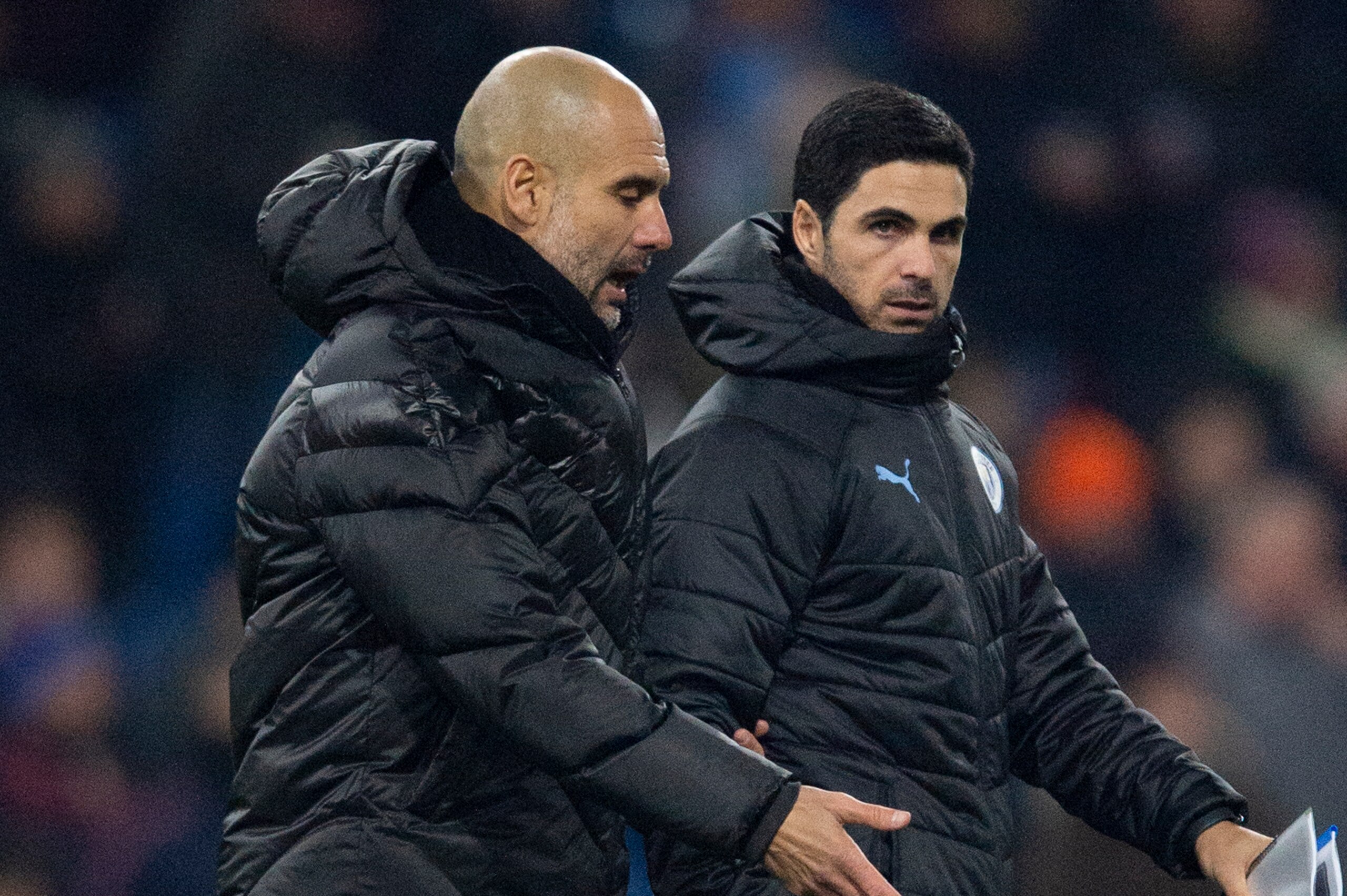 BURNLEY, ENGLAND - DECEMBER 03: Manchester City manager Pep Guardiola and his assistant coach Mikel Arteta walk across the pitch at half time during the Premier League match between Burnley FC and Manchester City at Turf Moor on December 3, 2019 in Burnle