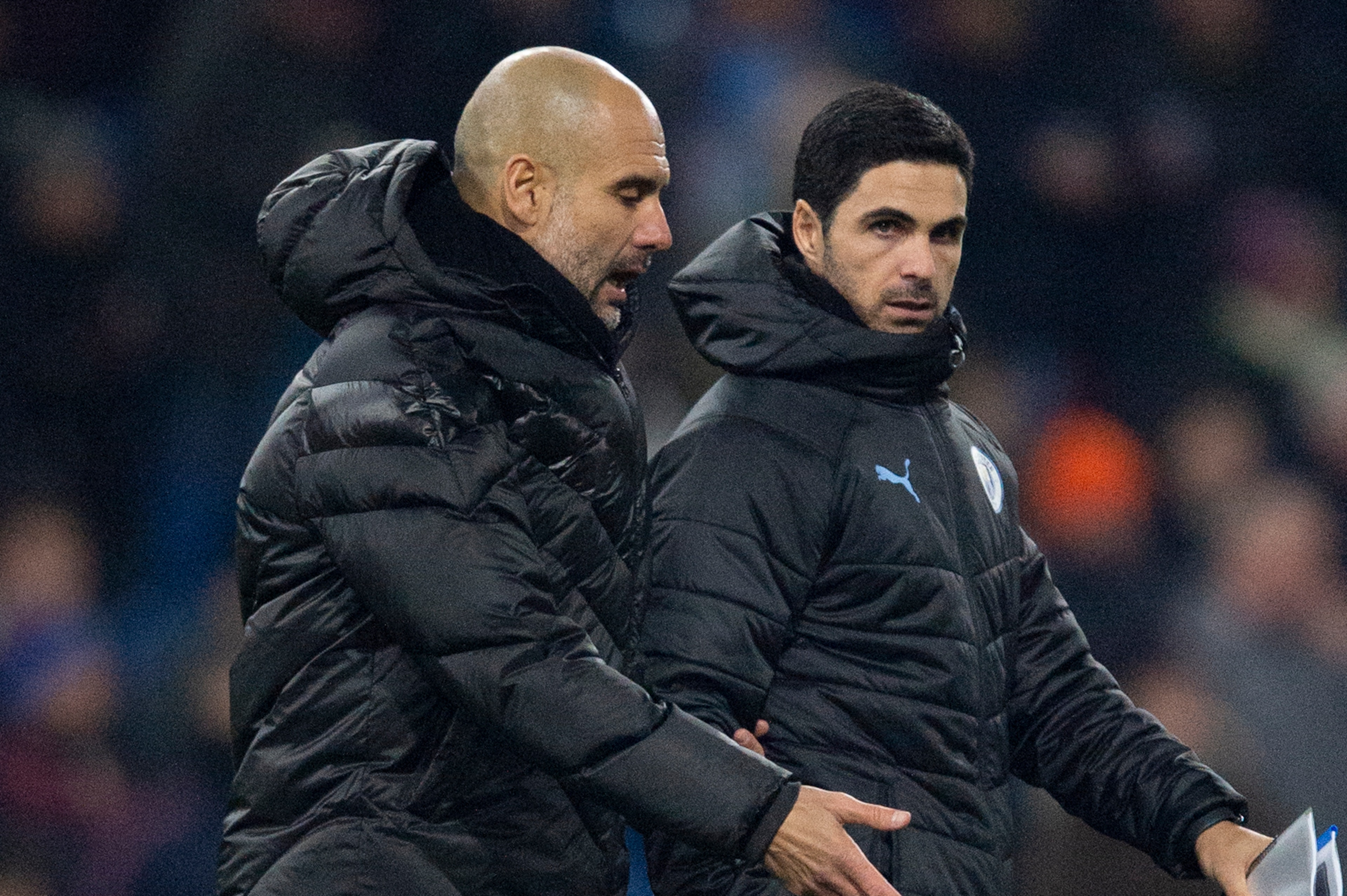 BURNLEY, ENGLAND - DECEMBER 03: Manchester City manager Pep Guardiola and his assistant coach Mikel Arteta walk across the pitch at half time during the Premier League match between Burnley FC and Manchester City at Turf Moor on December 3, 2019 in Burnle