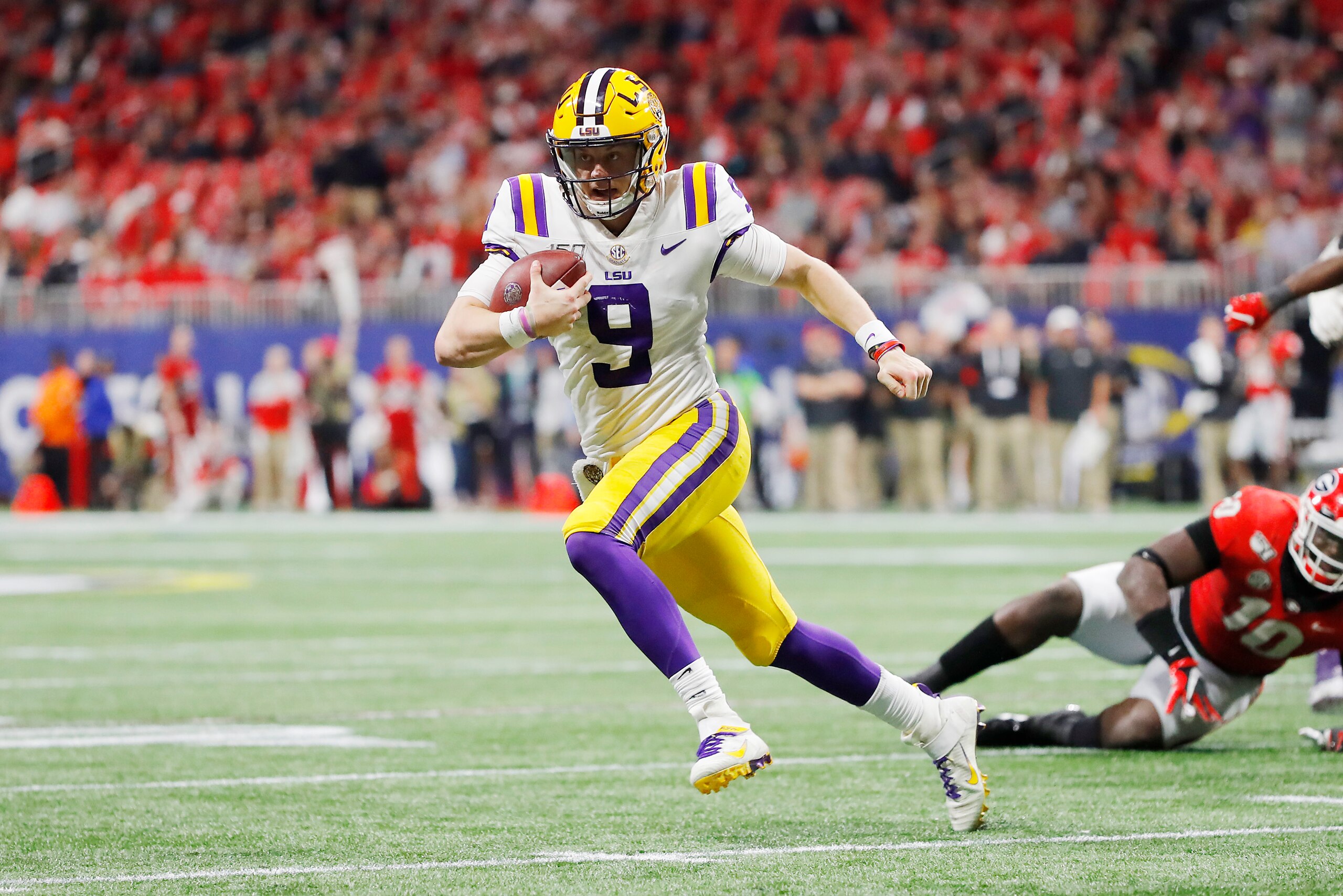 ATLANTA, GEORGIA - DECEMBER 07: Joe Burrow #9 of the LSU Tigers runs with the ball in the second half against the Georgia Bulldogs during the SEC Championship game at Mercedes-Benz Stadium on December 07, 2019 in Atlanta, Georgia. (Photo by Kevin C. Cox/G