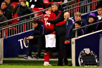 LONDON, ENGLAND - JANUARY 13: Jesse Lingard of Manchester United hugs Manager of Manchester United Ole Gunnar Solskjaer as he is substituted during the Premier League match between Tottenham Hotspur and Manchester United at Wembley Stadium on January 13, 