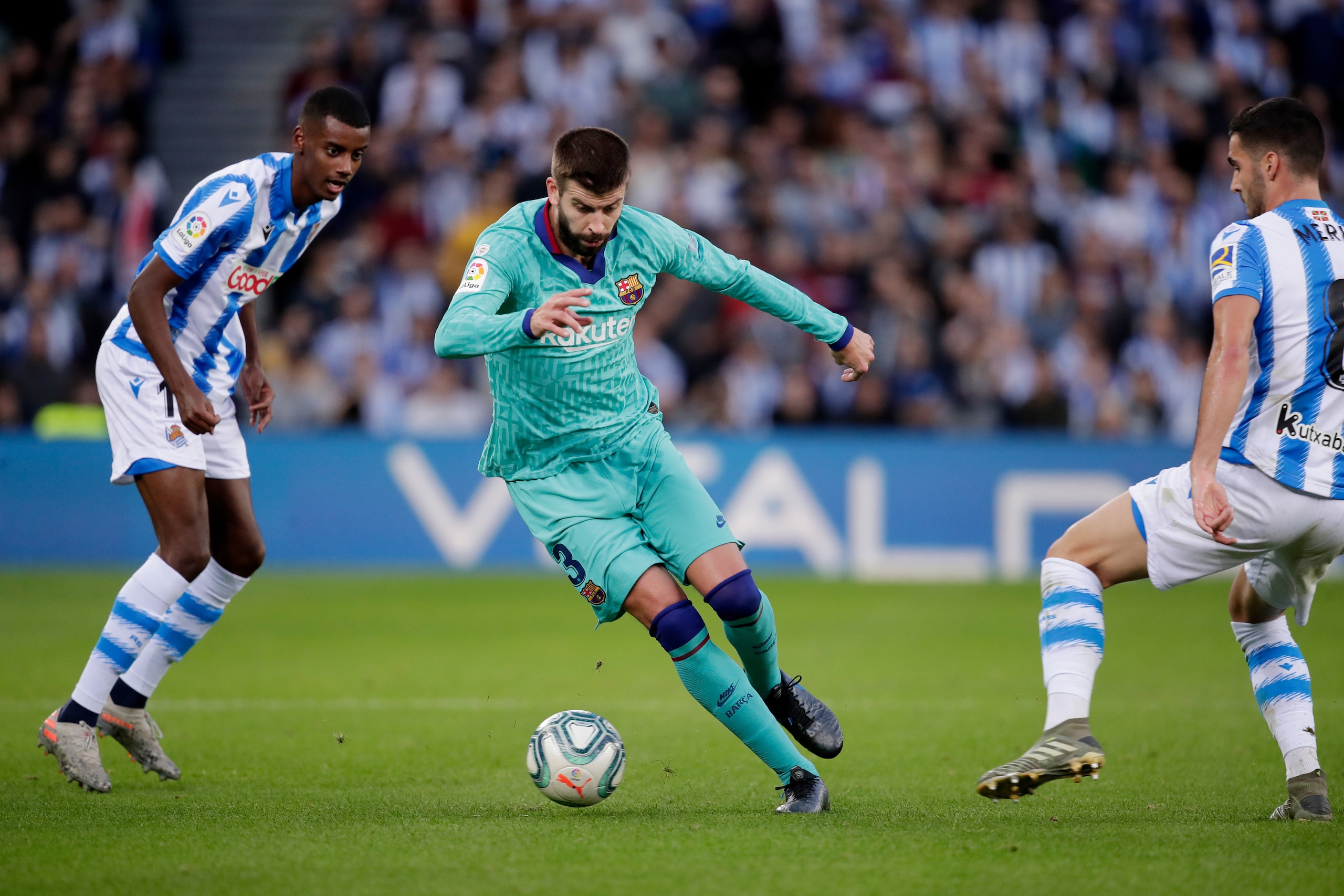 SAN SEBASTIAN, SPAIN - DECEMBER 14: (L-R) Alexander Isak of Real Sociedad, Gerard Pique of FC Barcelona  during the La Liga Santander  match between Real Sociedad v FC Barcelona at the Estadio Anoeta on December 14, 2019 in San Sebastian Spain (Photo by D