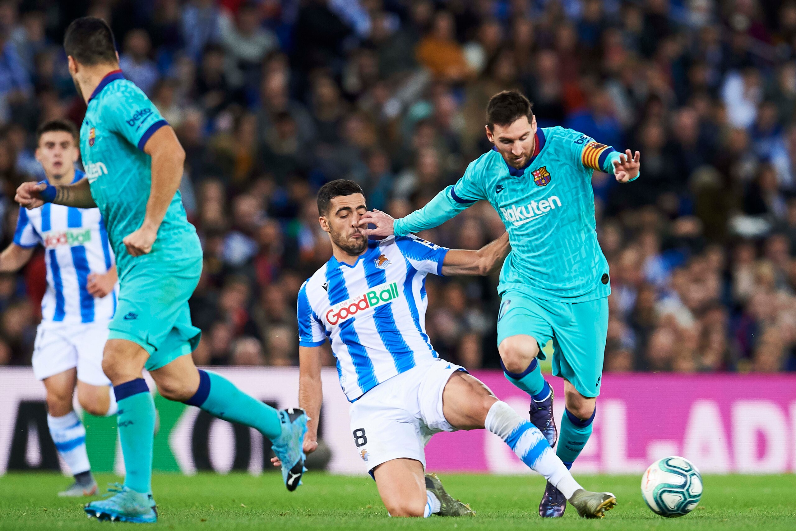 SAN SEBASTIAN, SPAIN - DECEMBER 14: Lionel Messi of FC Barcelona duels for the ball with Mikel Merino of Real Sociedad during the Liga match between Real Sociedad and FC Barcelona at Estadio Anoeta on December 14, 2019 in San Sebastian, Spain. (Photo by J