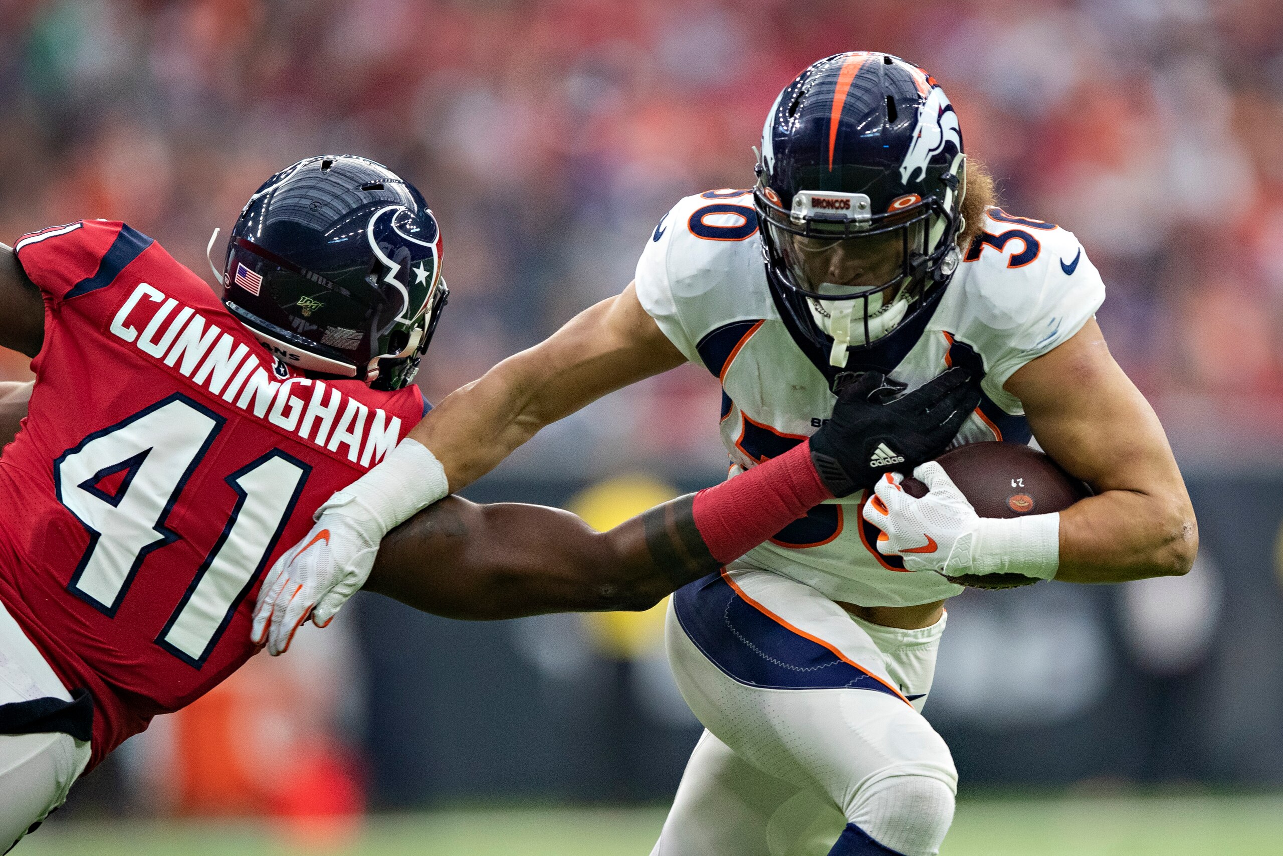 HOUSTON, TX - DECEMBER 8: Phillip Lindsay #30 of the Denver Broncos runs the ball in the first half and breaks the tackle of Zach Cunningham #41 of the Houston Texans at NRG Stadium on December 8, 2019 in Houston, Texas. The Broncos defeated the Texans HOUSTON, TX - DECEMBER 8: Phillip Lindsay #30 of the Denver Broncos runs the ball in the first half and breaks the tackle of Zach Cunningham #41 of the Houston Texans at NRG Stadium on December 8, 2019 in Houston, Texas. The Broncos defeated the Texans