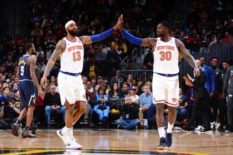 DENVER, CO - DECEMBER 15: Marcus Morris Sr. #13 of the New York Knicks and Julius Randle #30 of the New York Knicks high-five during a game against the Denver Nuggets on December 15, 2019 at the Pepsi Center in Denver, Colorado. NOTE TO USER: User express