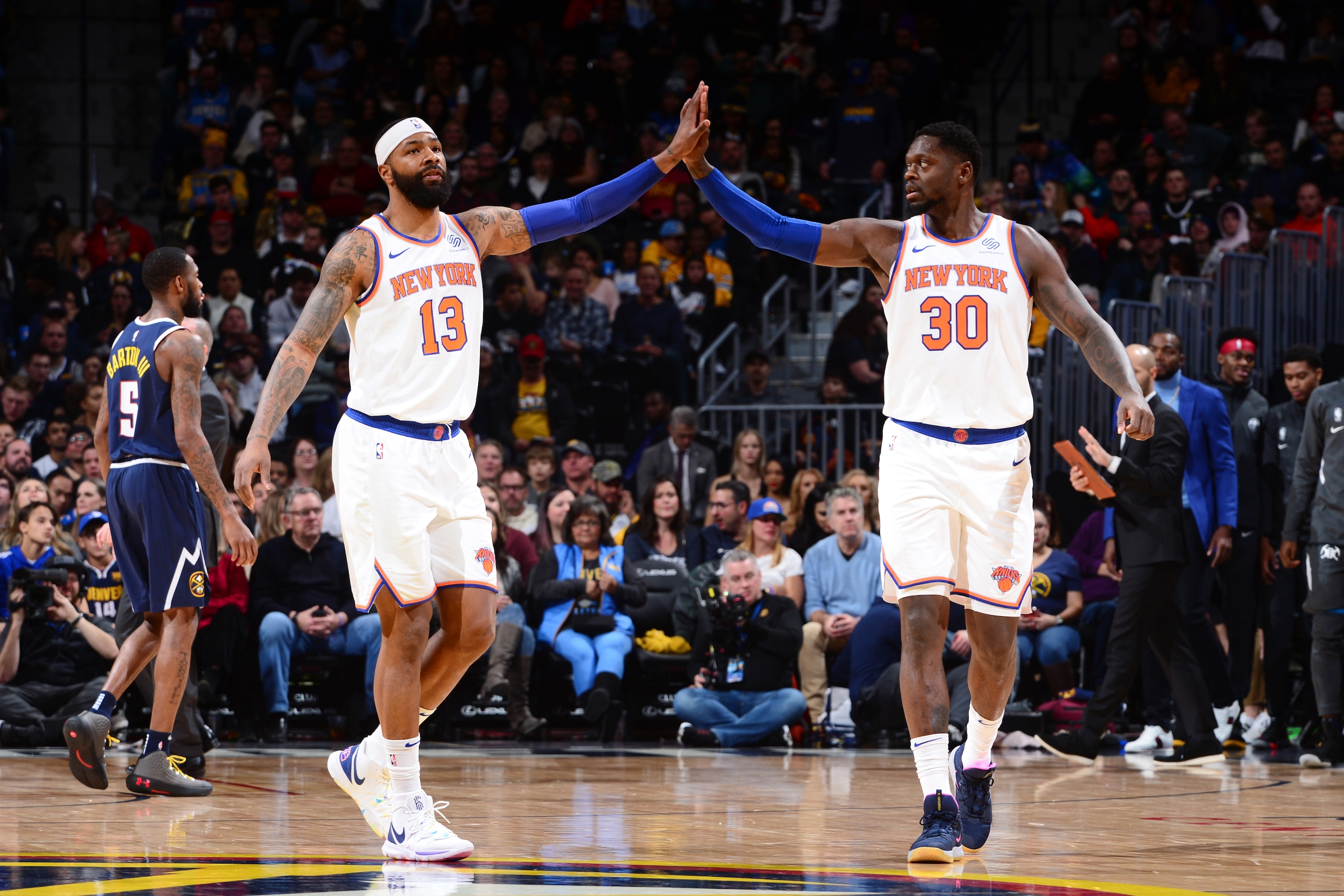 DENVER, CO - DECEMBER 15: Marcus Morris Sr. #13 of the New York Knicks and Julius Randle #30 of the New York Knicks high-five during a game against the Denver Nuggets on December 15, 2019 at the Pepsi Center in Denver, Colorado. NOTE TO USER: User express