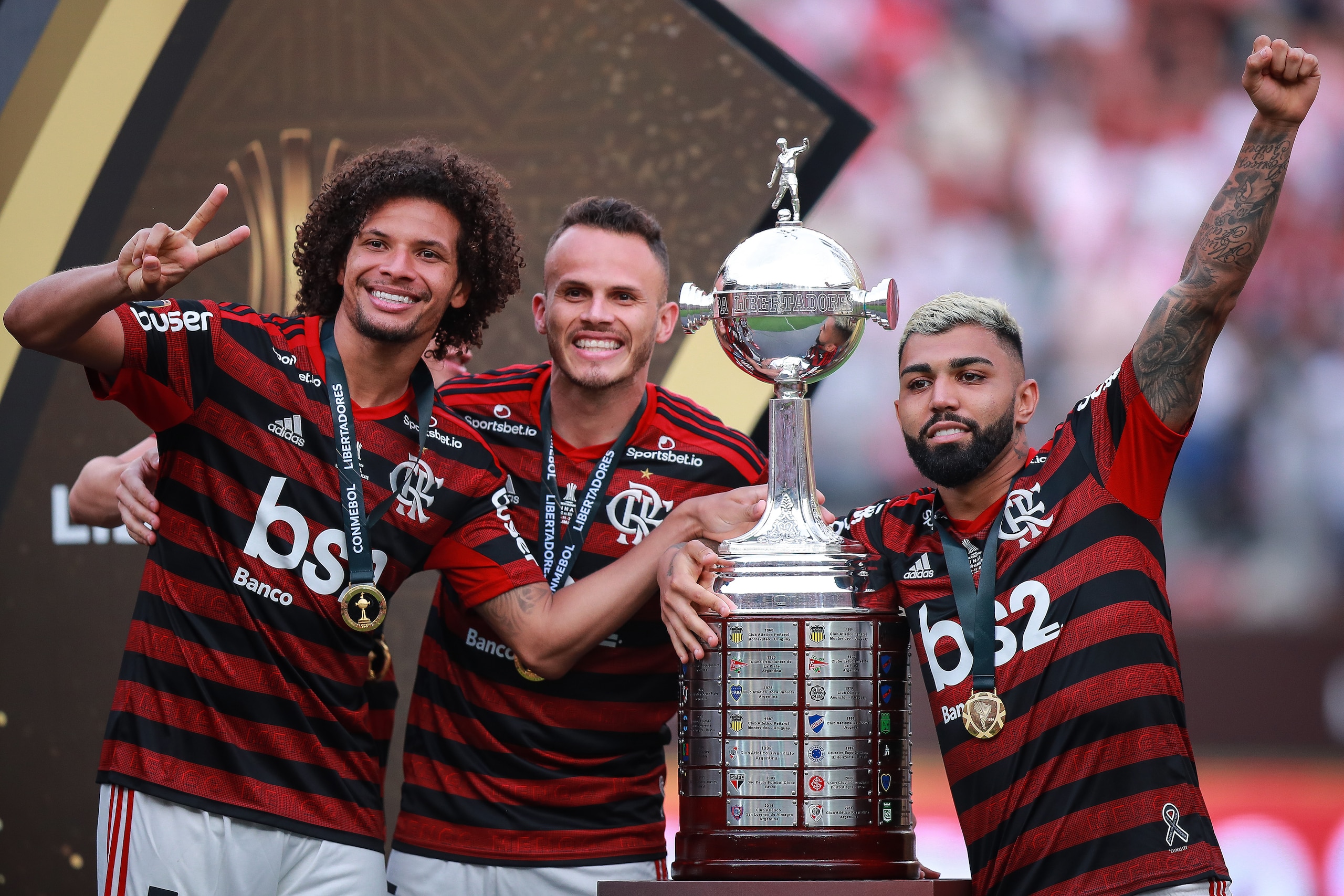 LIMA, PERU - NOVEMBER 23: Willian Arao #5, Rene #6, Gabriel Barbosa #9 of Flamengo celebrates with the CONMEBOL trophy after winning the final match of Copa CONMEBOL Libertadores 2019 between Flamengo and River Plate at Estadio Monumental on November 23, 
